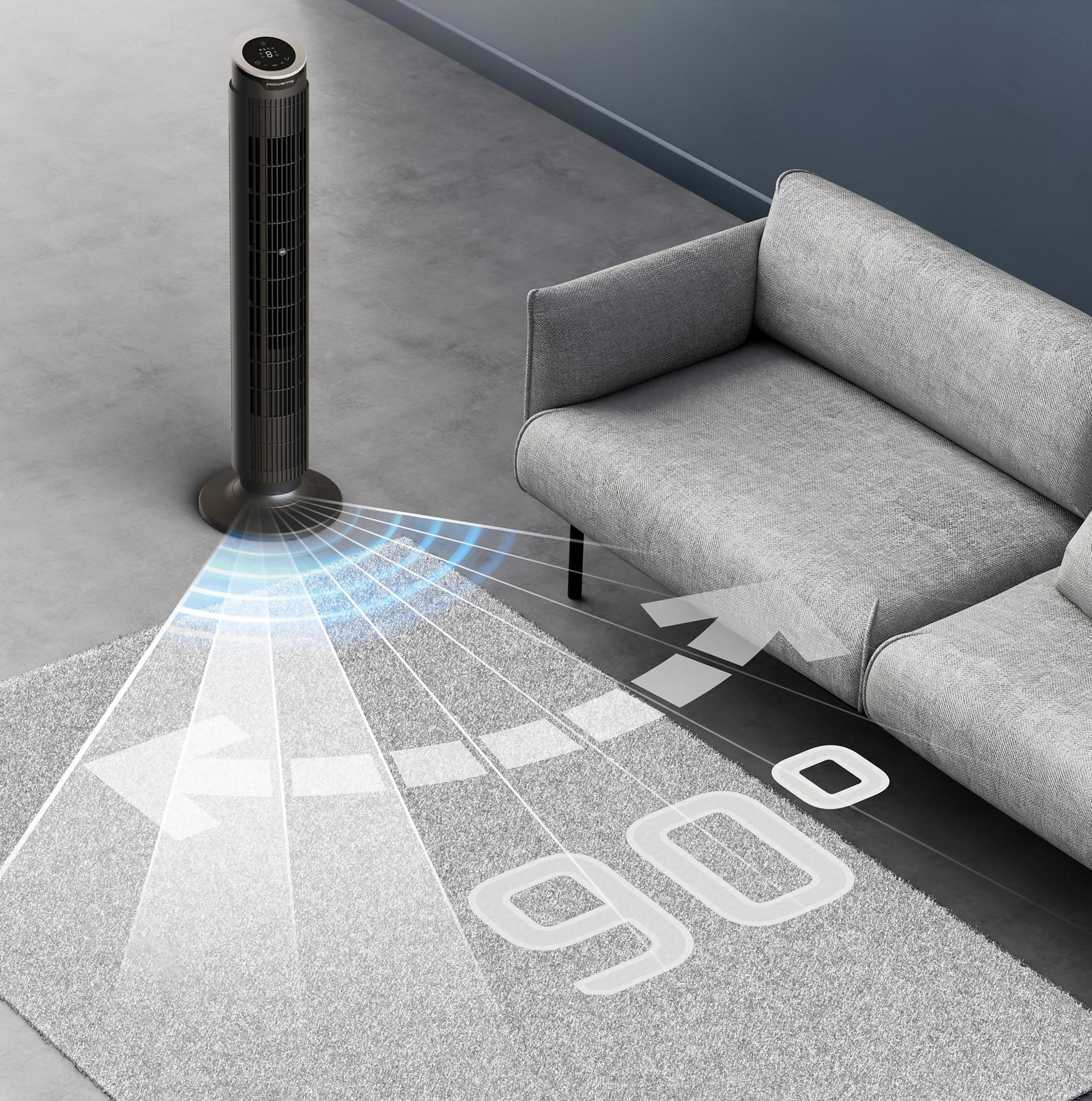 Ein schlanker Turmventilator mit blauer Luftstromanzeige neben einem grauen Sofa.