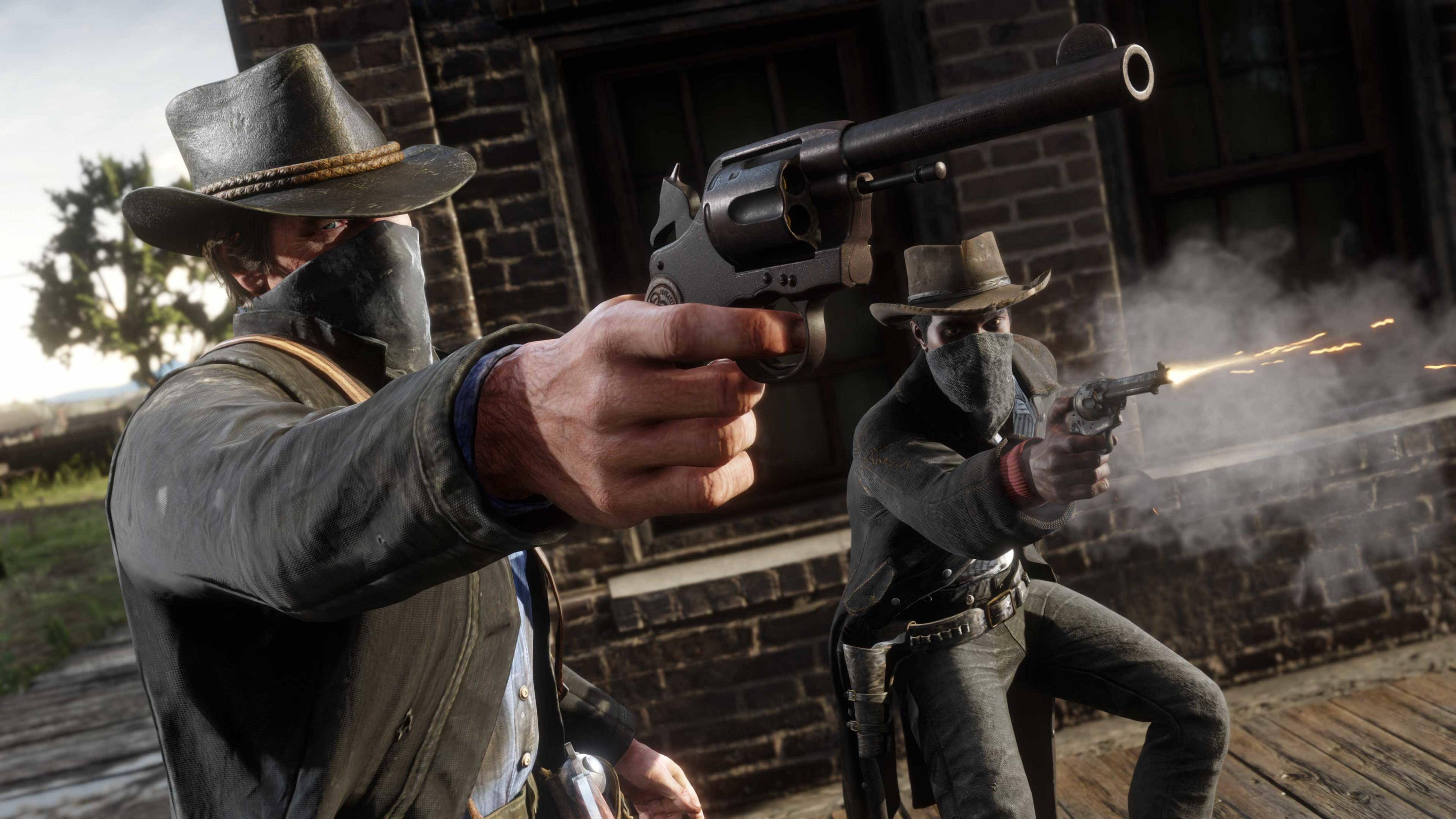 Due uomini in abiti da cowboy sparano con revolver. Uno mira avanti, l'altro sta sparando.