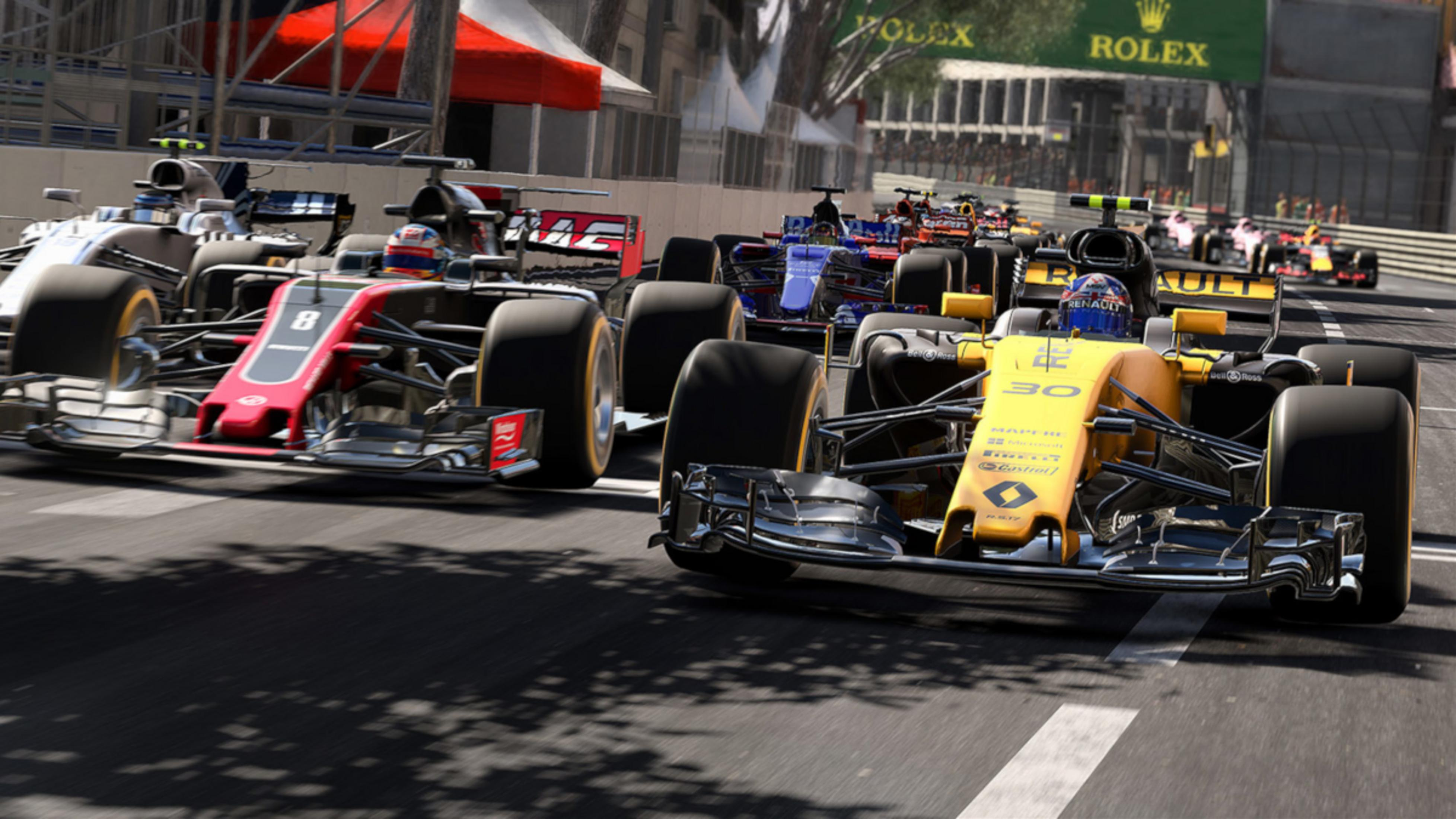 Diverse auto di Formula 1 corrono su una pista, con spettatori sullo sfondo.
