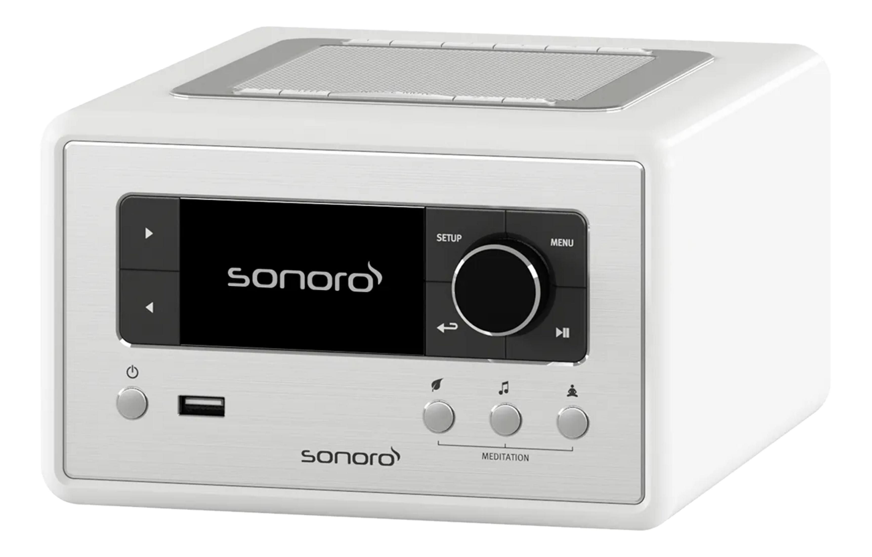 A white radio with a black screen and control buttons.