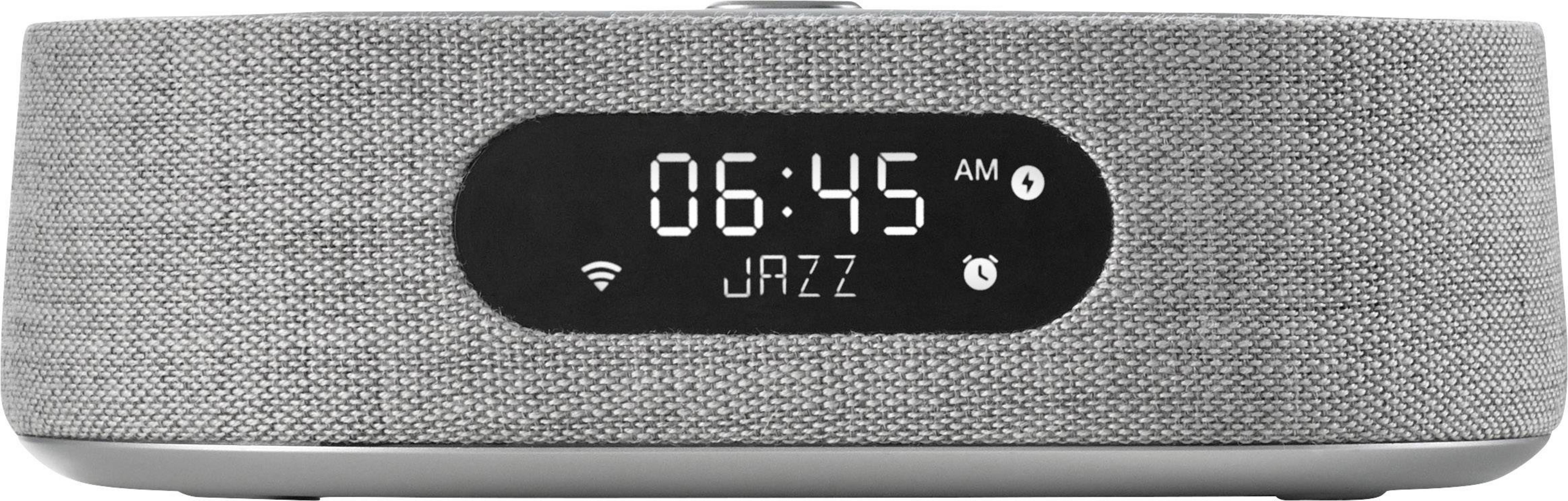 Grauer Lautsprecher mit digitaler Anzeige: 06:45 AM, JAZZ.