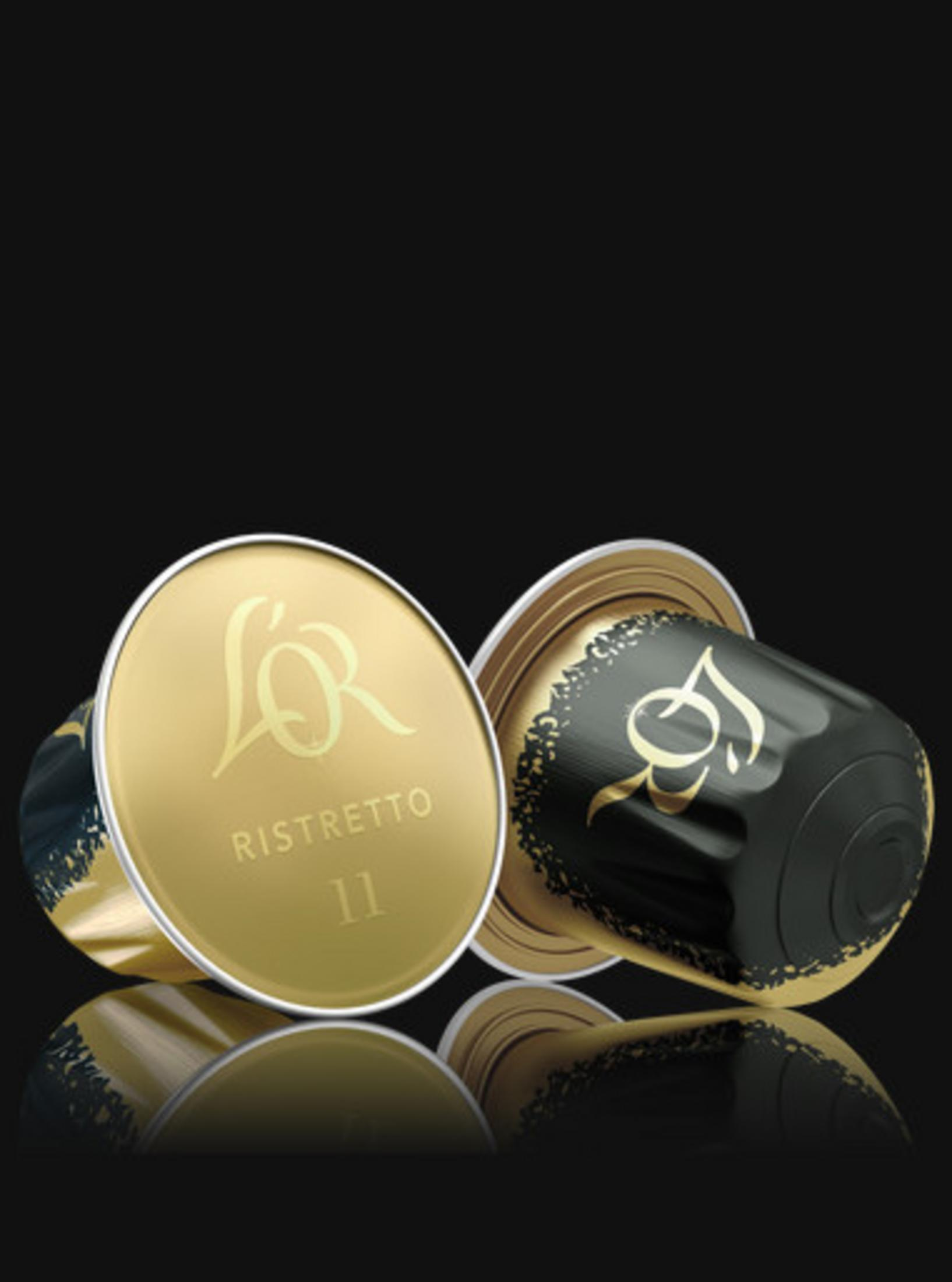 Due capsule di caffè oro e nero con logo L'OR.