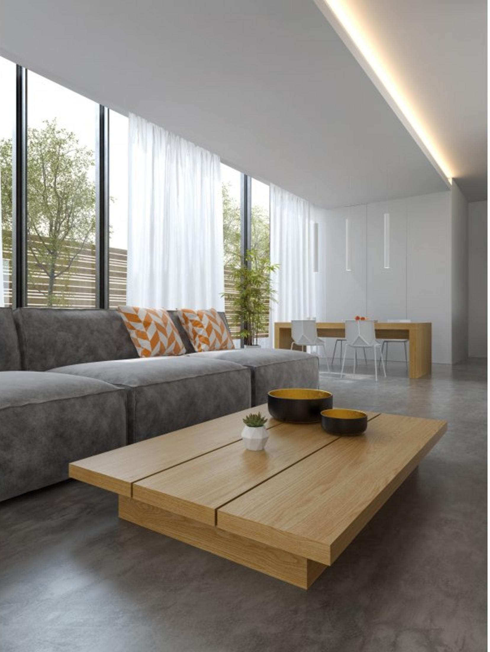 Ein modernes Wohnzimmer mit Sofa, Couchtisch, Esstisch und Stühlen.