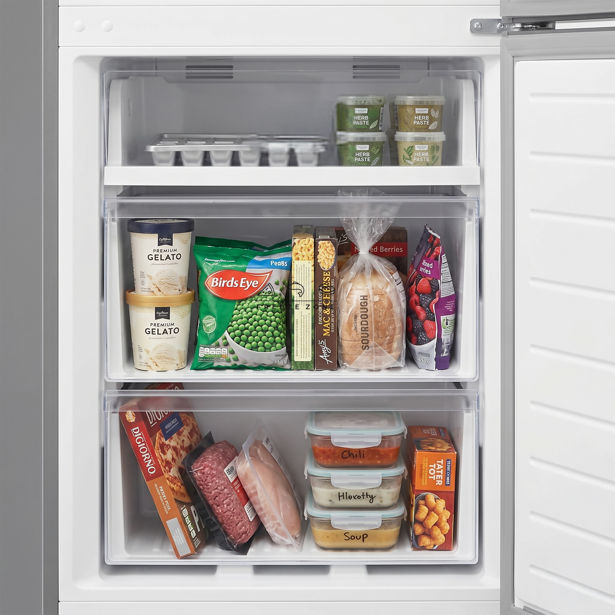 Freezer stocked with ice cream, peas, bread, berries, pizza, ground meat, chicken, soups.