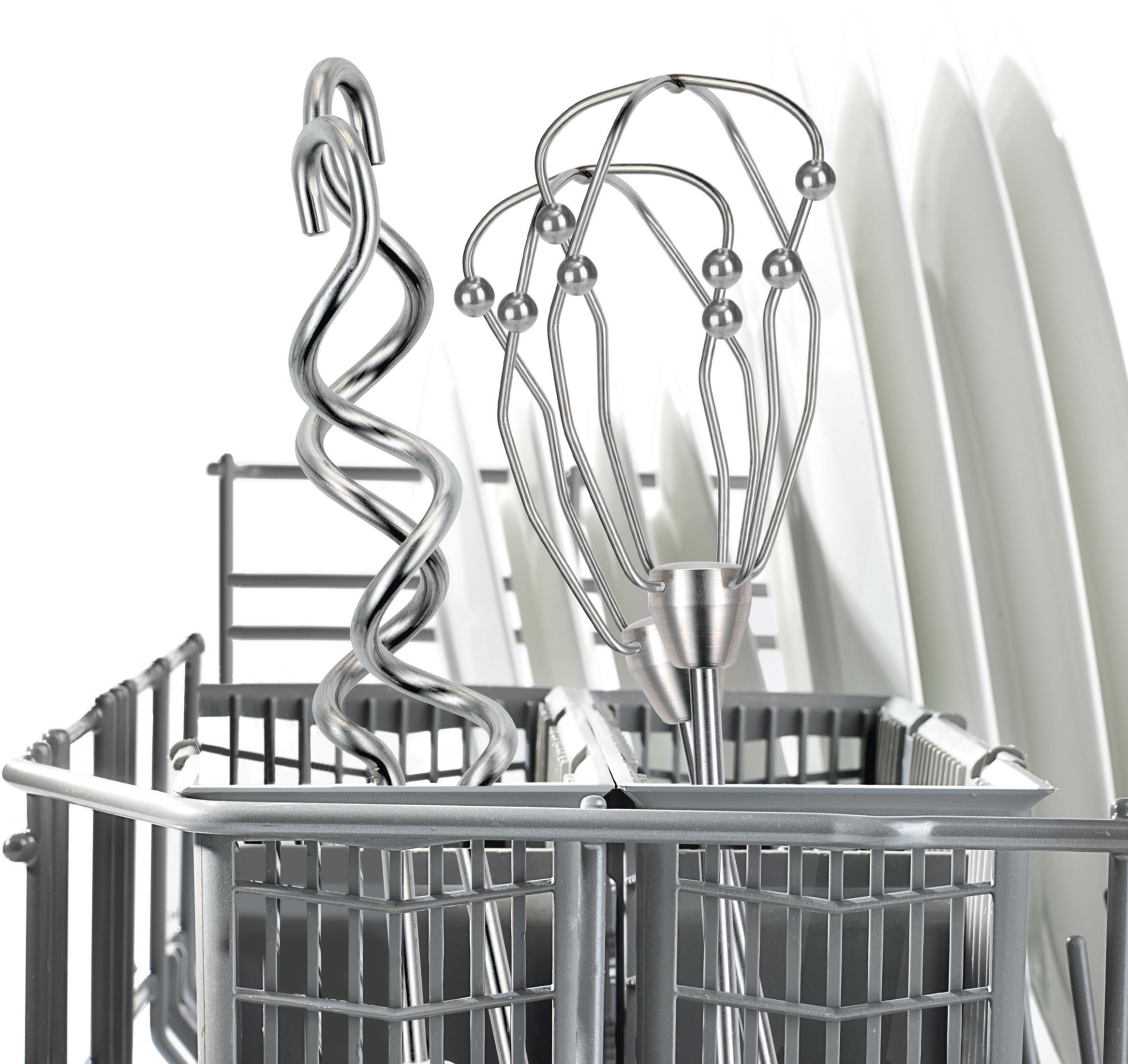 Utensili da cucina in acciaio inox, frusta e spirale, in un cestello per lavastoviglie con piatti.
