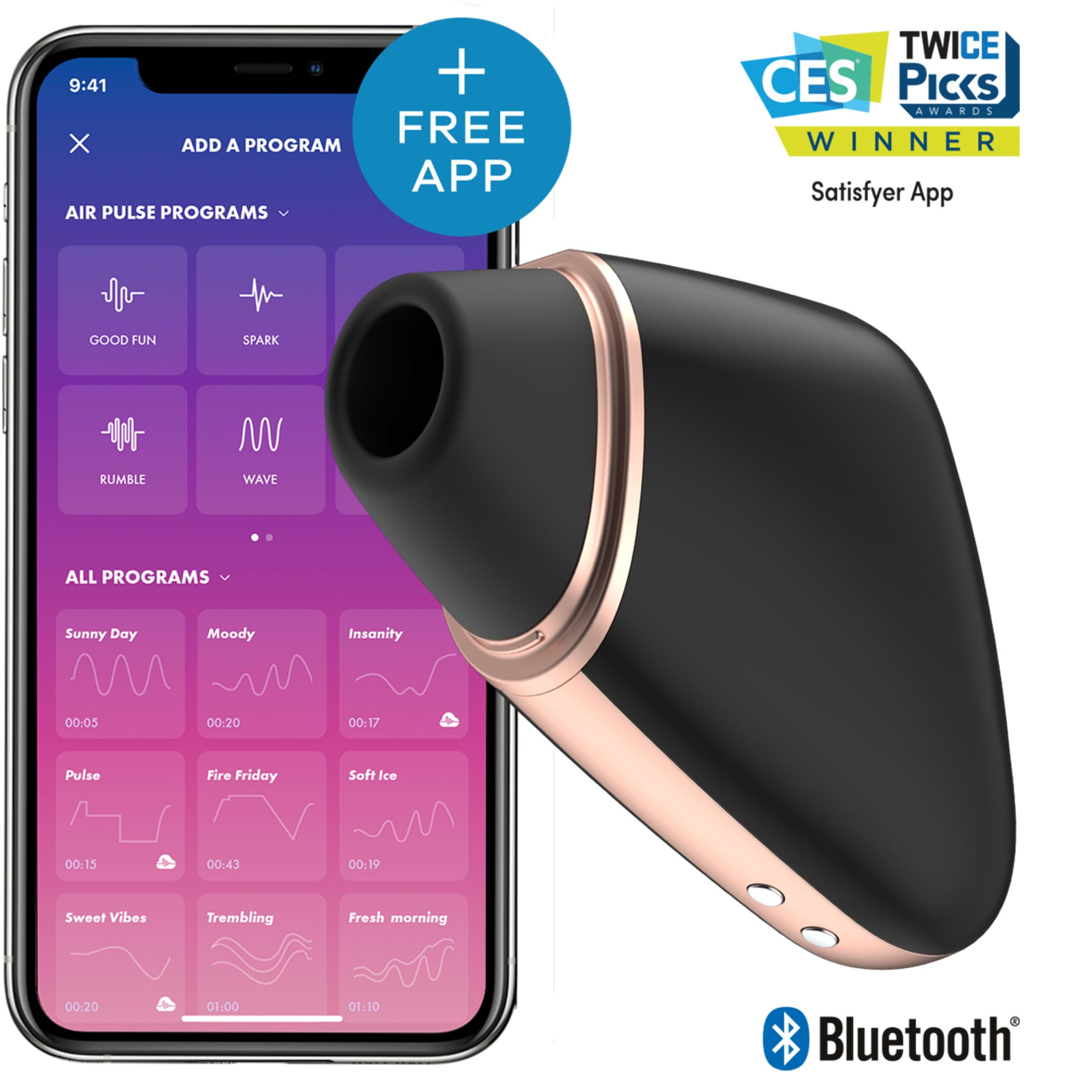 Un dispositivo negro con detalles en oro rosa descansa junto a un smartphone con interfaz de app.