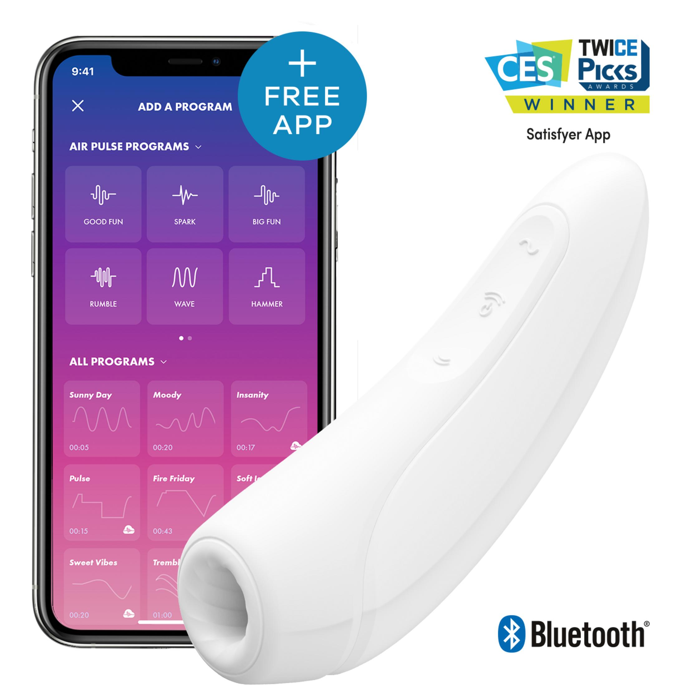 Un masajeador Satisfyer blanco junto a un smartphone con programas de app.