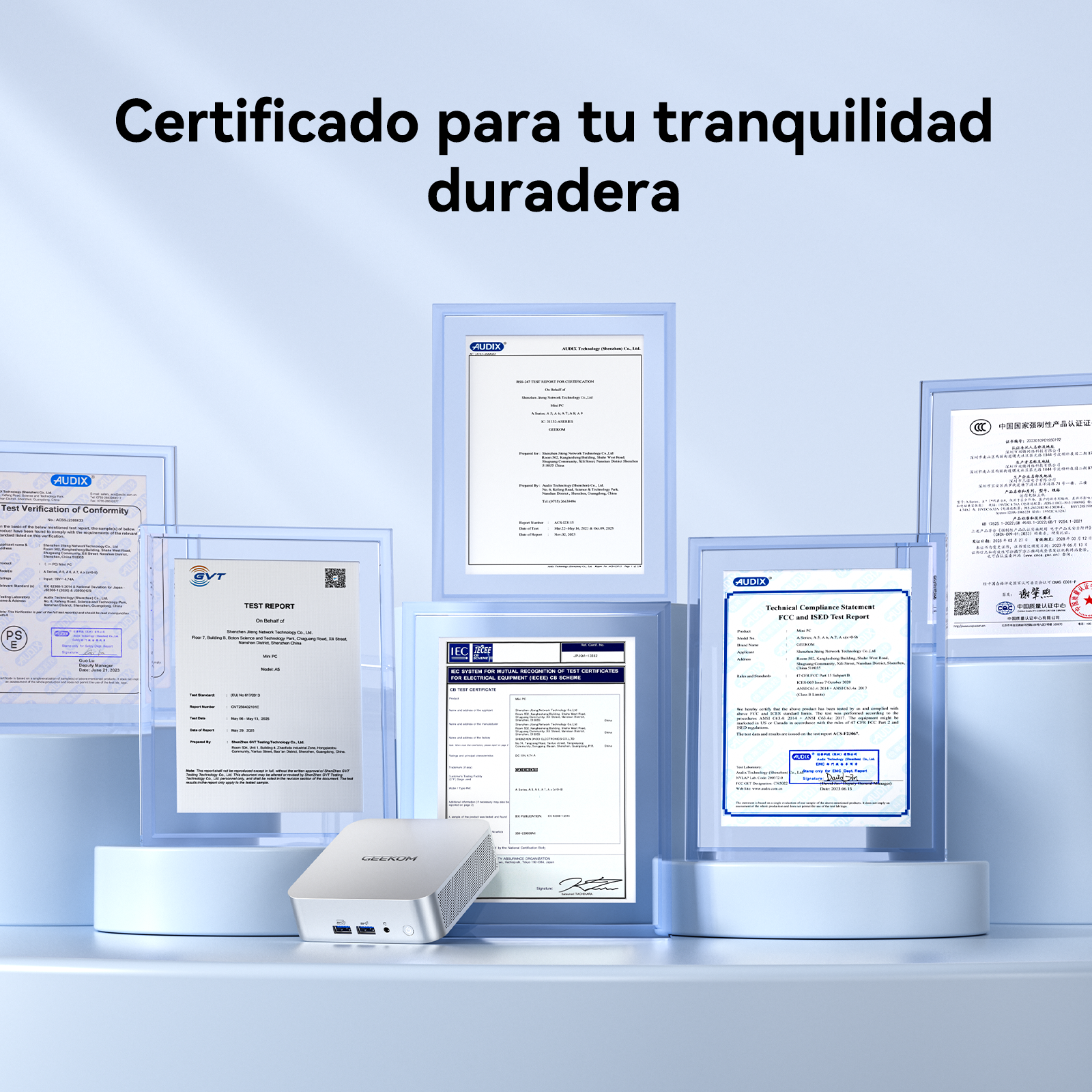 Múltiples certificados y una pequeña computadora plateada sobre fondo azul claro.