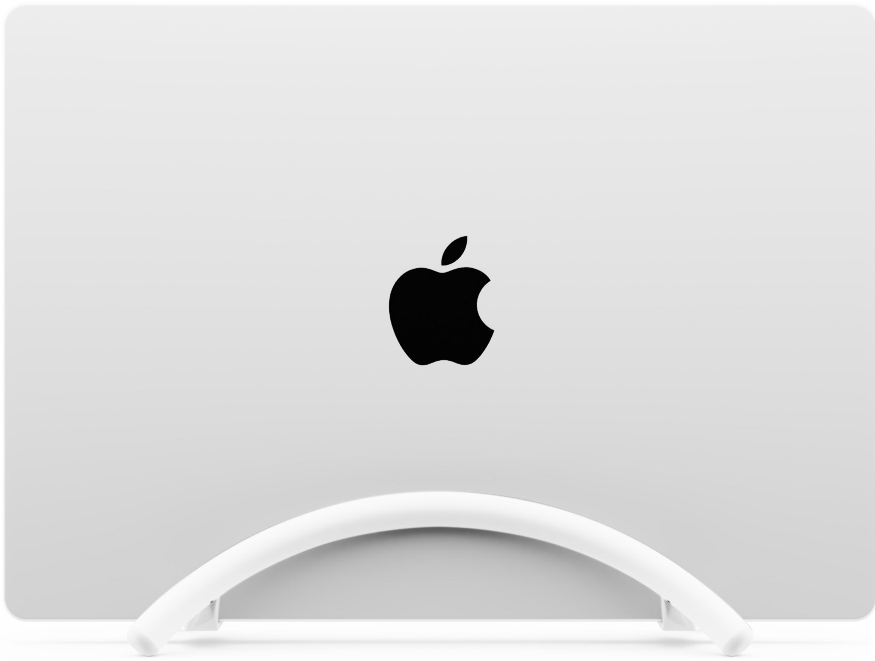 Un laptop bianco con logo Apple nero sul retro, appoggiato su un supporto bianco.