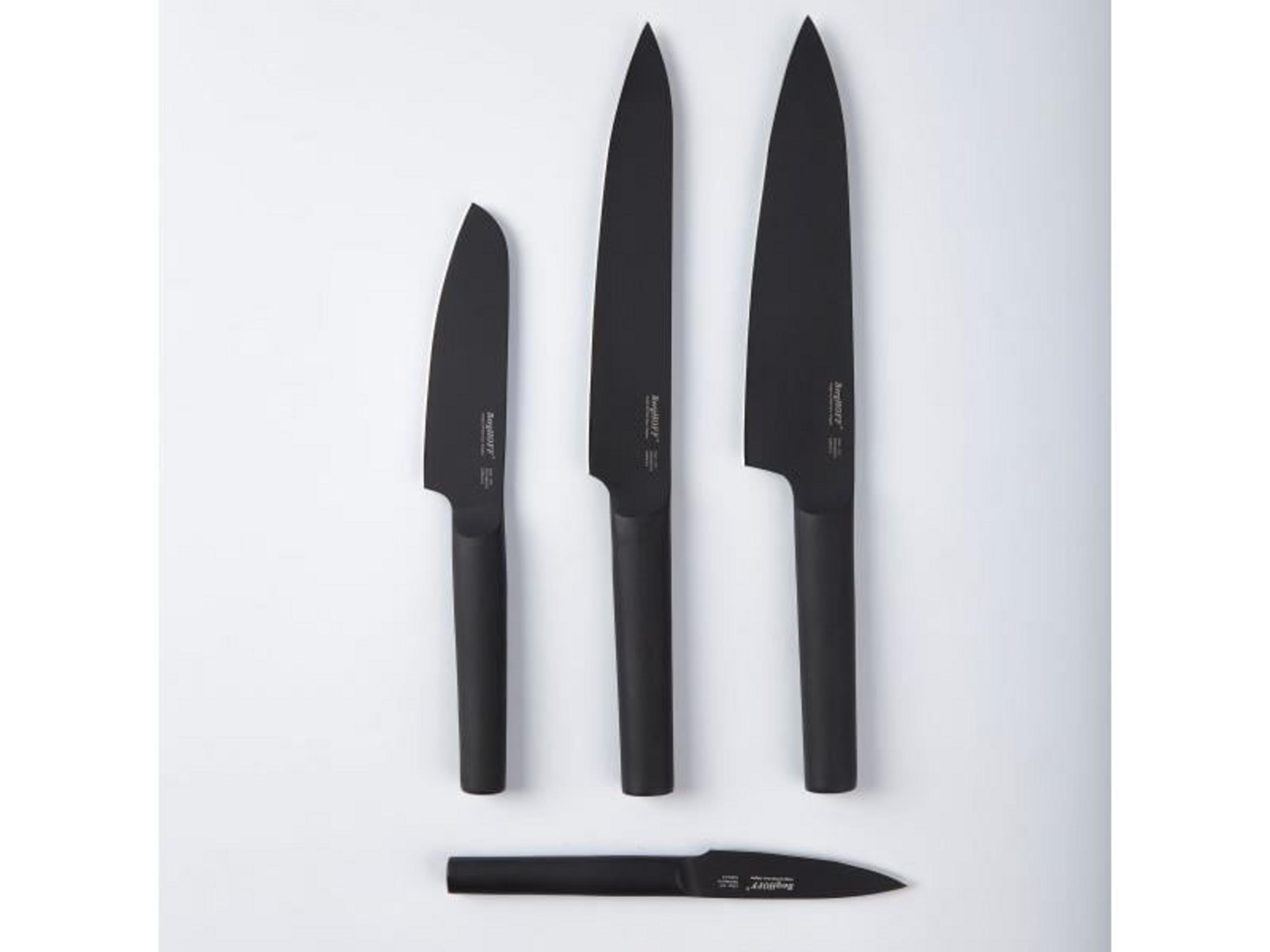 Three black knives with handles, a small knife lies below.