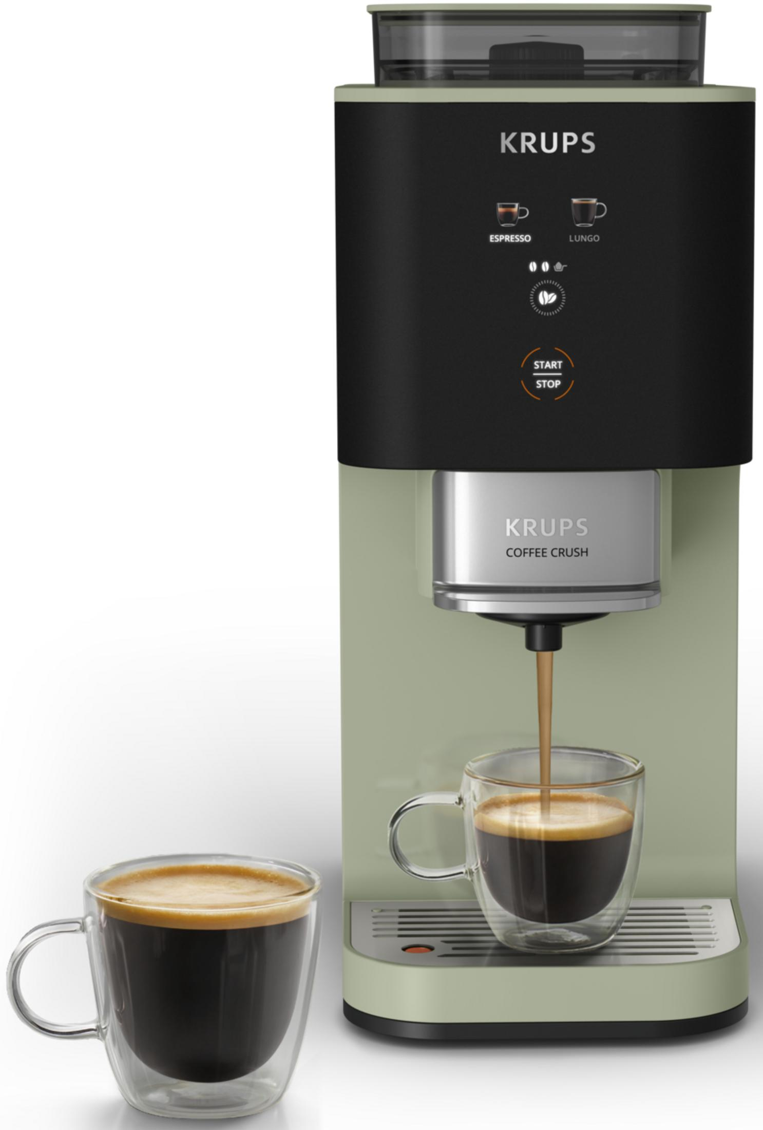 Una macchina da caffè Krups verde con due bicchieri di espresso, uno in fase di riempimento.