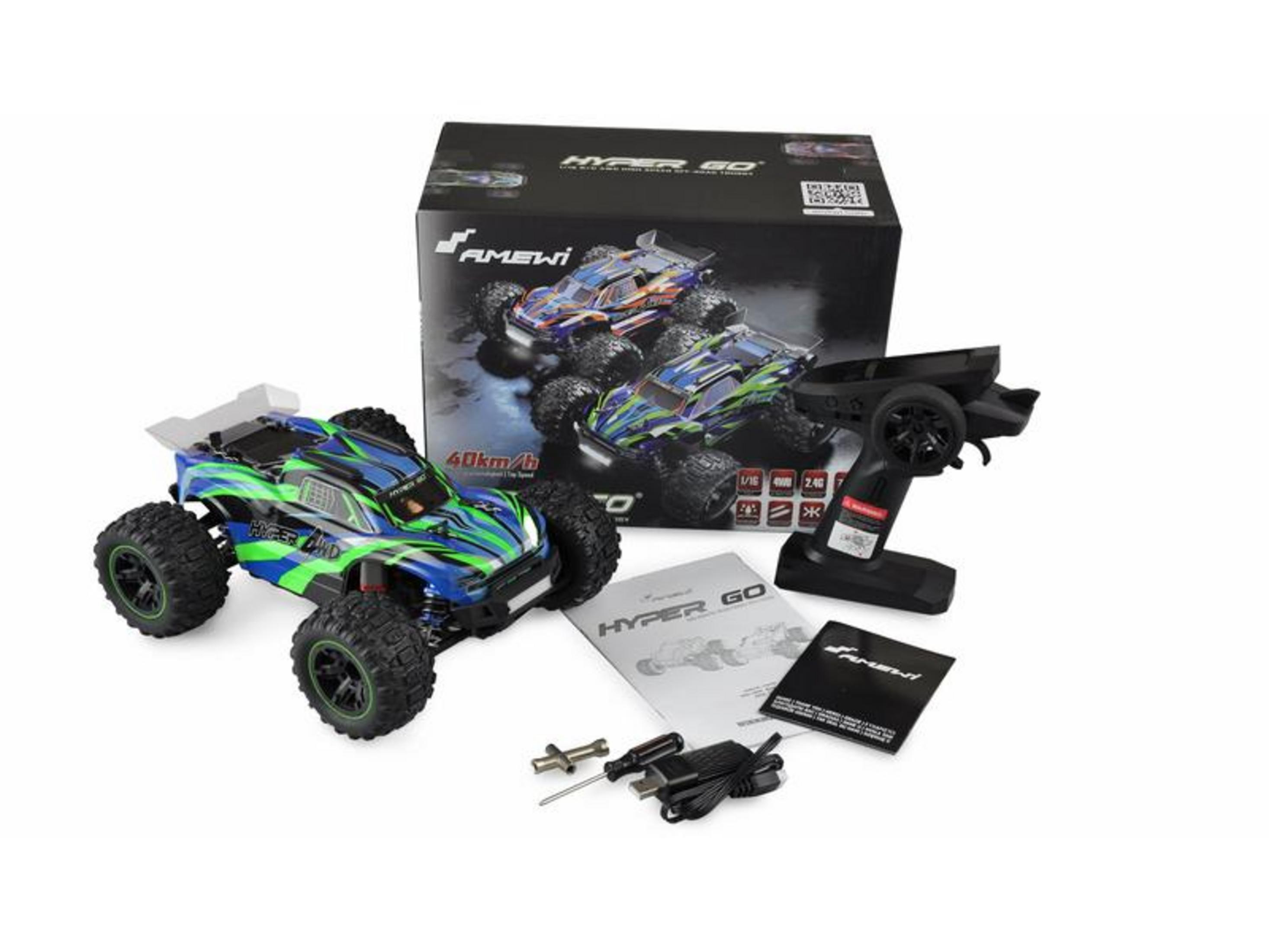 Un monster truck azul y verde a control remoto junto a su caja, mando e instrucciones.