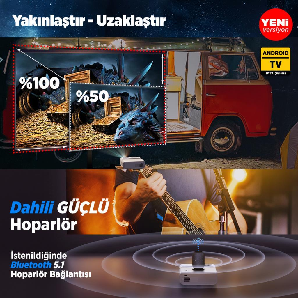 Bir projektör, bir kamyonetin önünde ejderha resmi gösteriyor. Altta bir adam gitar çalıyor.