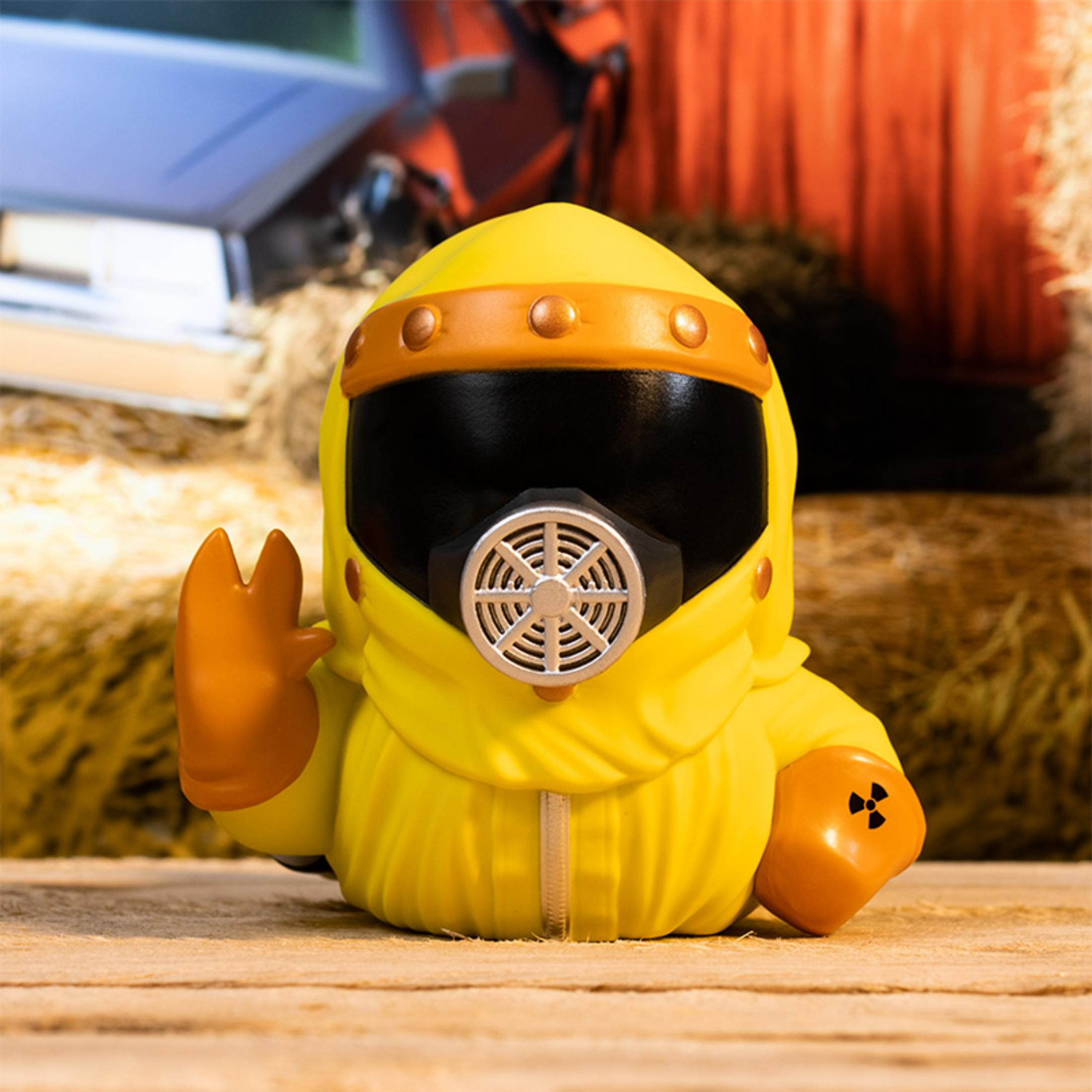 Eine gelbe Figur in Schutzanzug mit Gasmaske und radioaktivem Symbol.