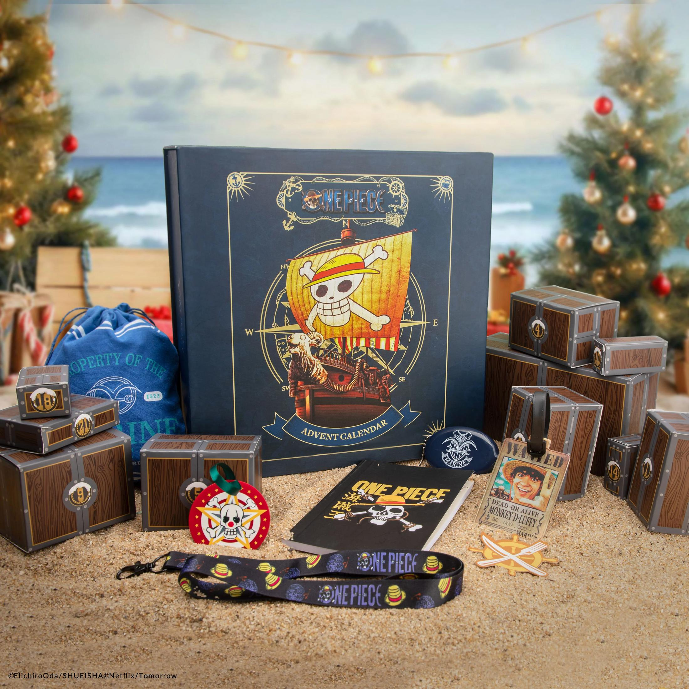 One Piece Adventskalender mit Schatztruhen, Beutel und Anhängern am Strand.
