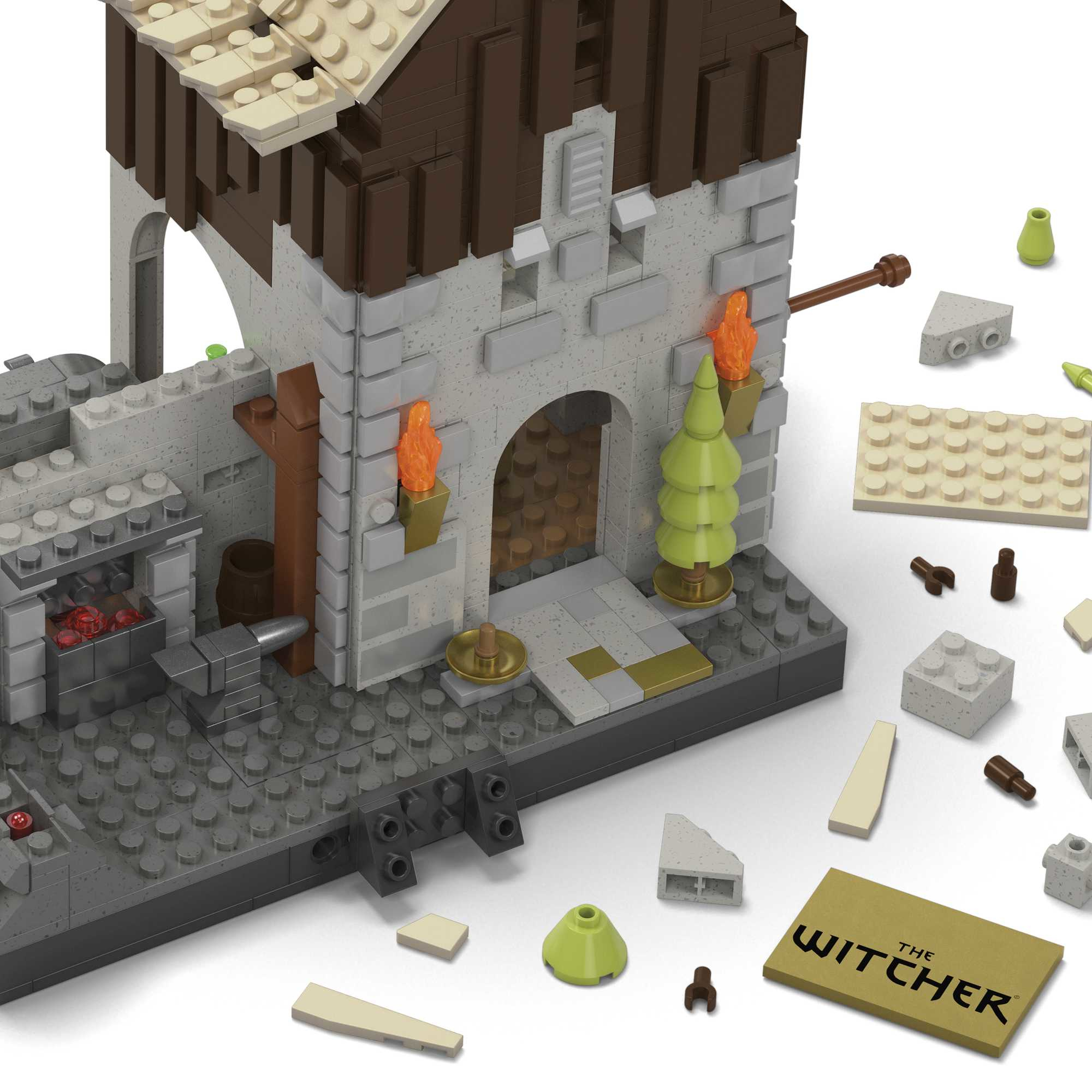 Un château Lego Witcher avec des pièces éparpillées et une tuile logo Witcher.