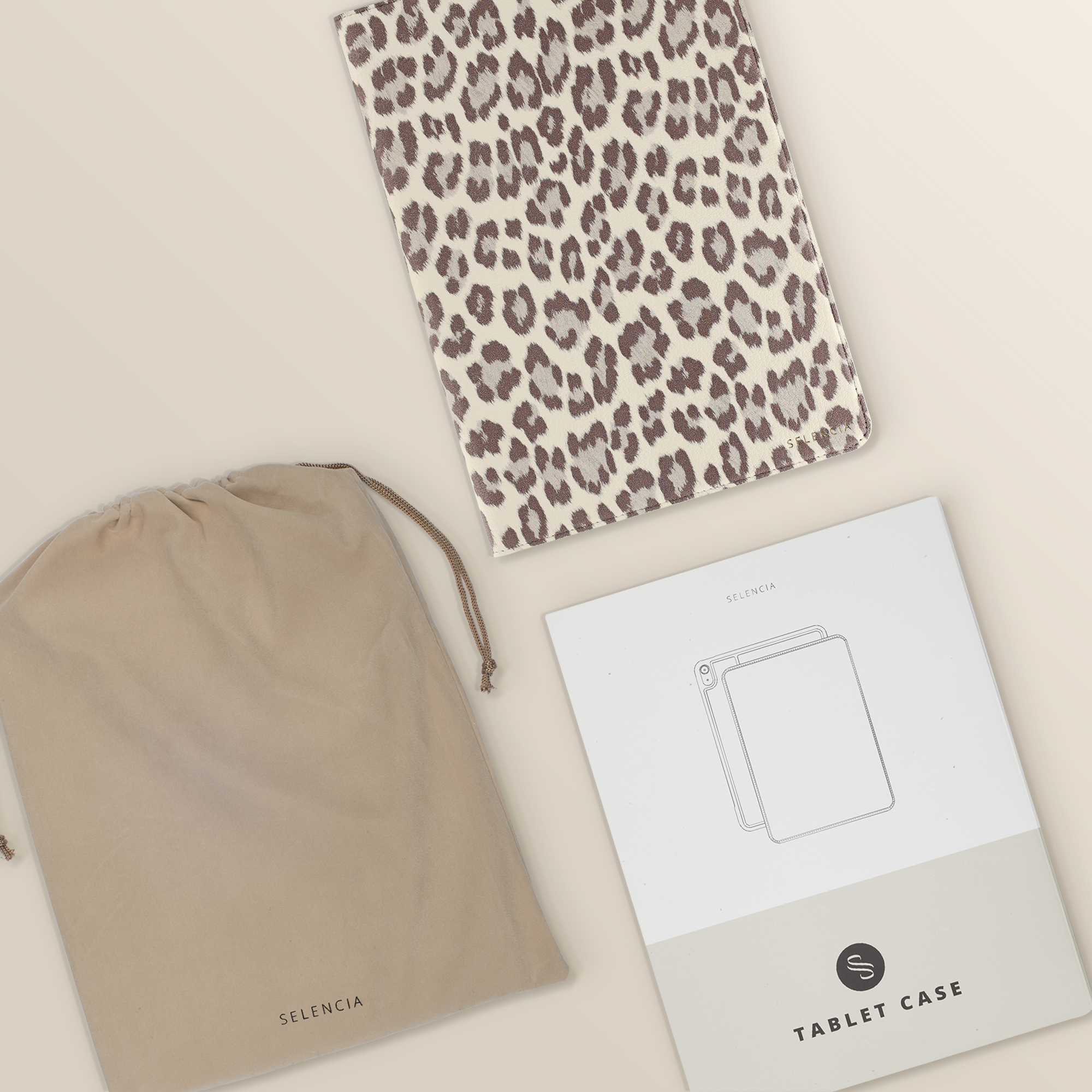 A leopard print tablet case, a beige pouch, and instructions lie on a light background.