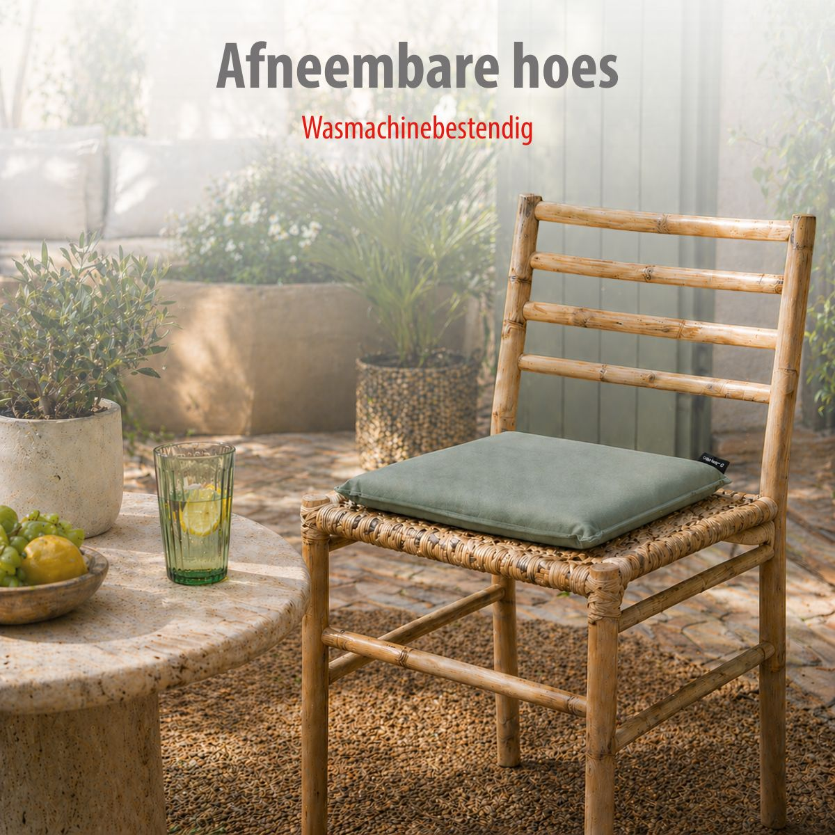 A wooden chair with cushion sits by a table with fruit and drink.