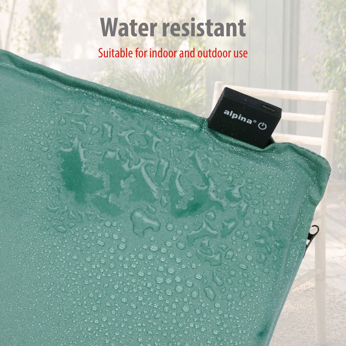 Green fabric with water droplets. A black box with 'alpina' is visible.