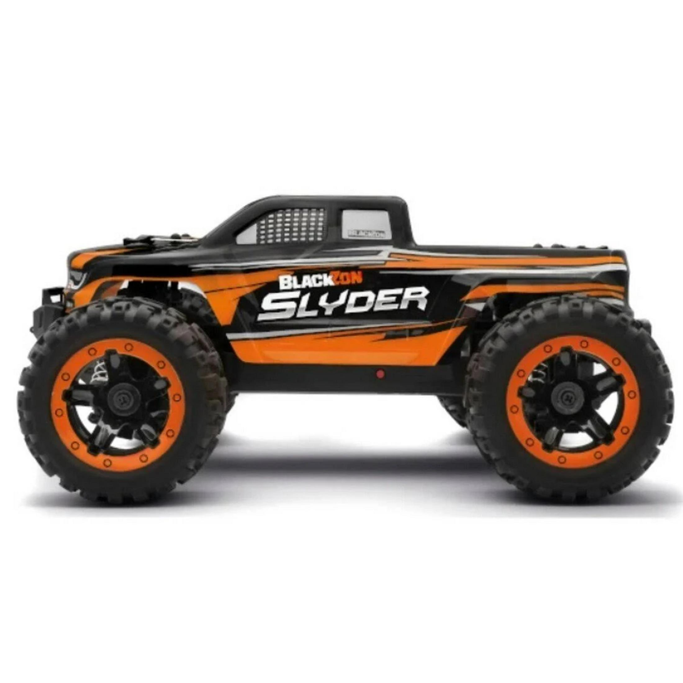 Un monster truck noir et orange télécommandé avec de gros pneus.