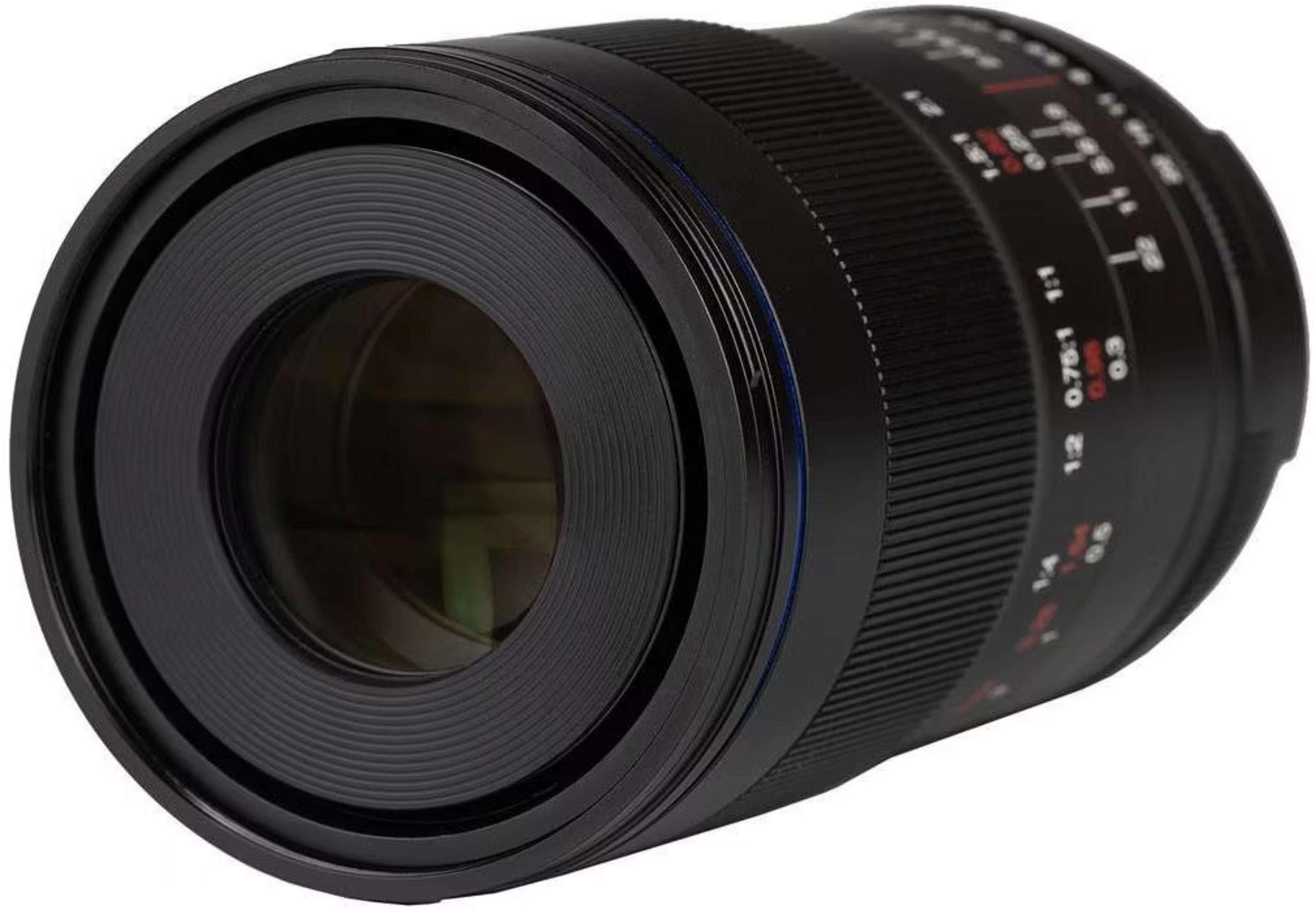 Close-up of a black camera lens with focus and aperture markings.