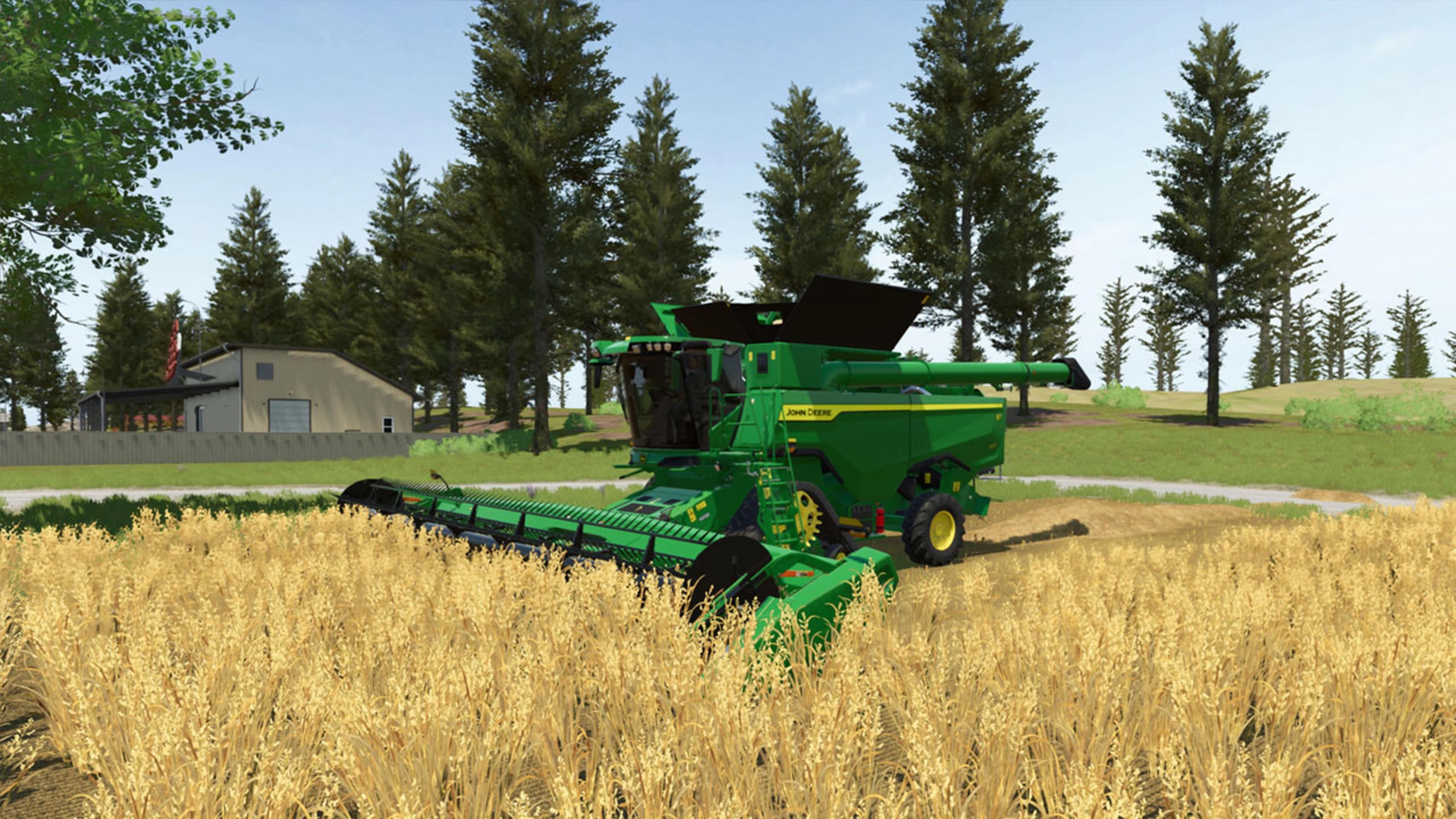 Ein grüner John Deere Mähdrescher erntet ein Feld mit goldenem Weizen.