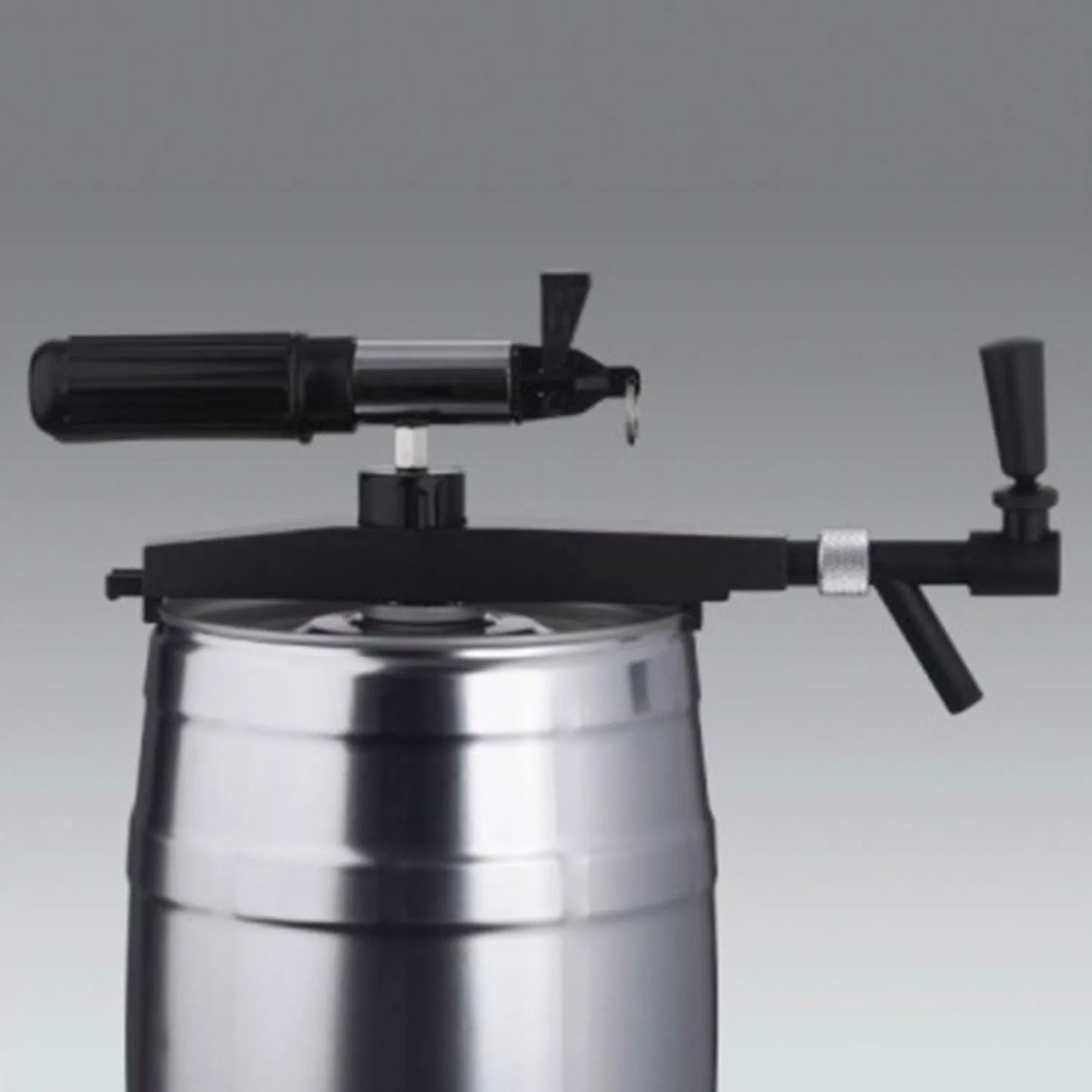 A silver tap is mounted on a metal keg.