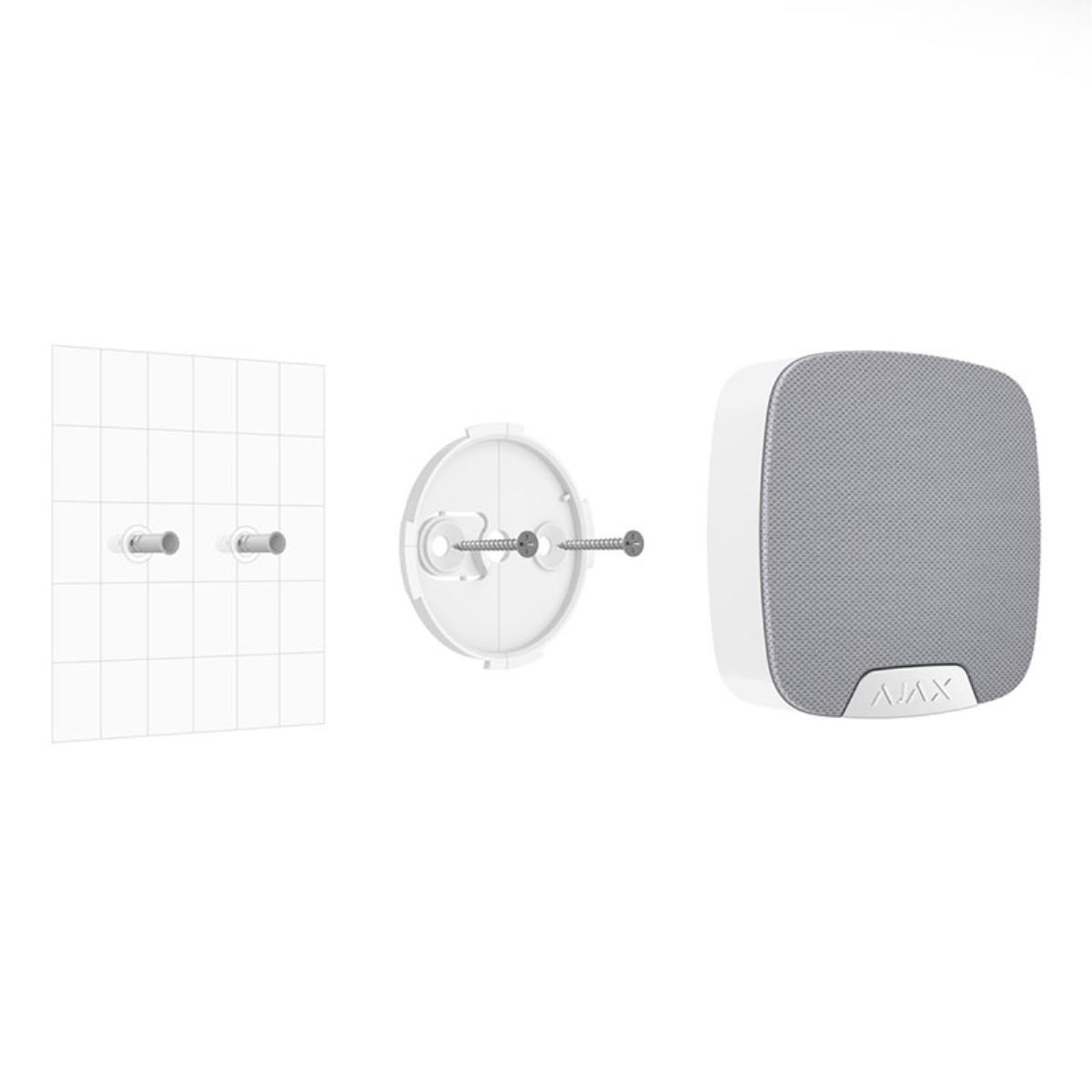 Un altavoz blanco con frente gris, junto a un soporte con tornillos.