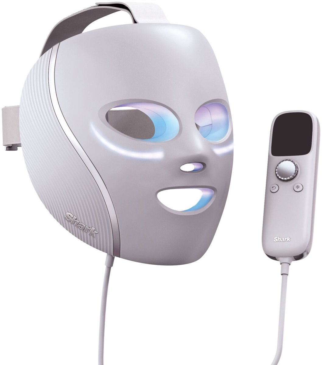 A white LED facial mask with a controller, used for skincare treatments.