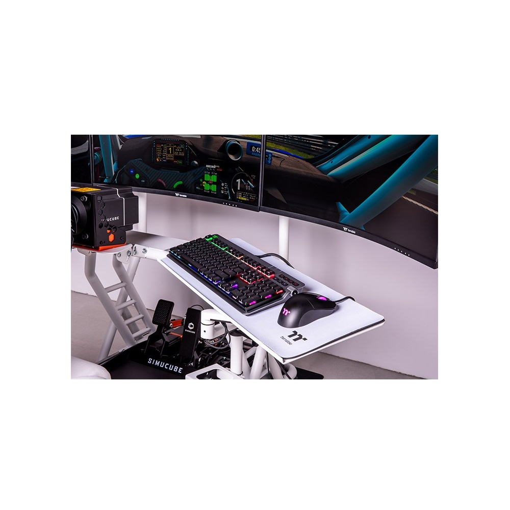 A racing simulator setup featuring a keyboard, mouse, and monitors.