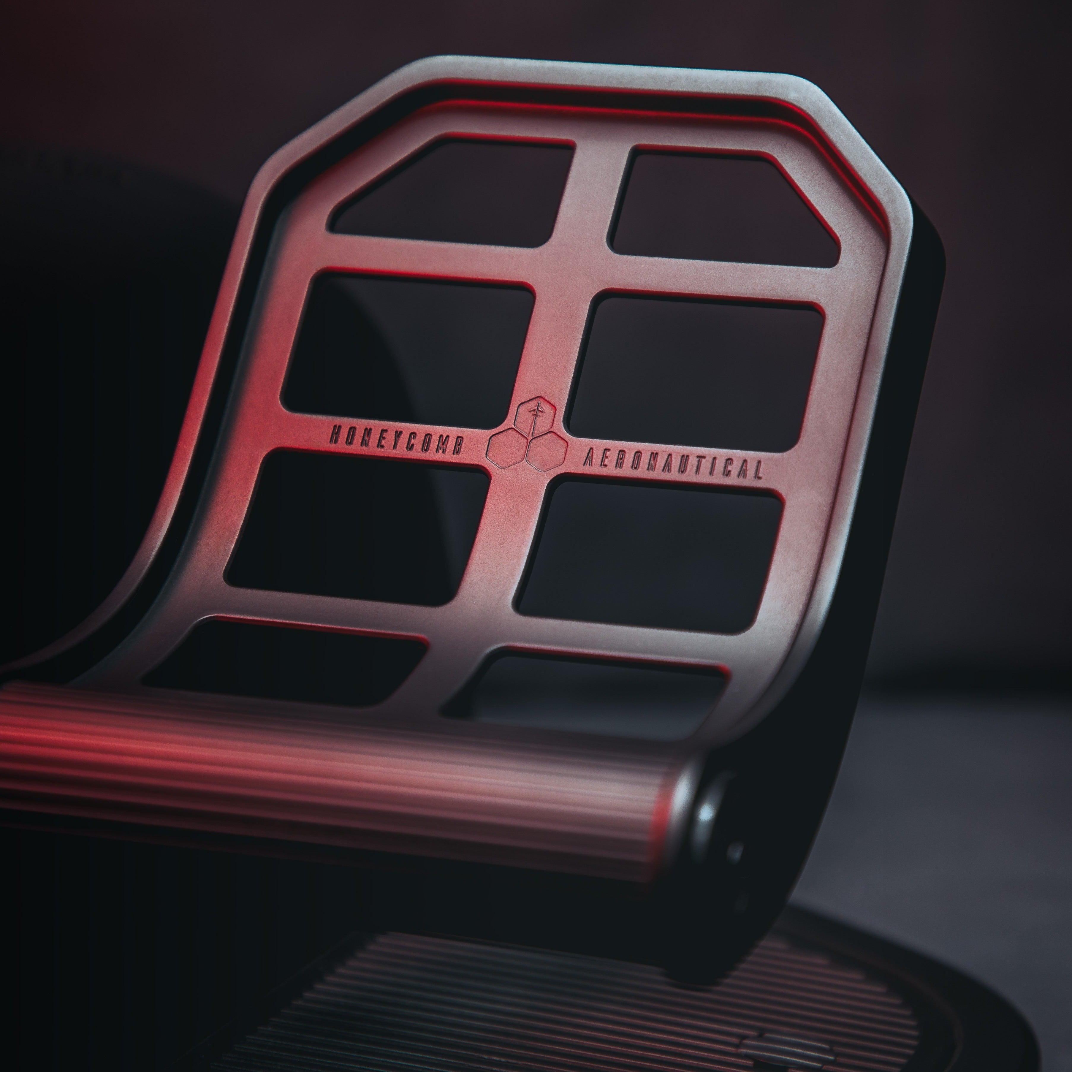 A metallic grid with red lighting and the words 'HONEYCOMB AERONAUTICAL'.