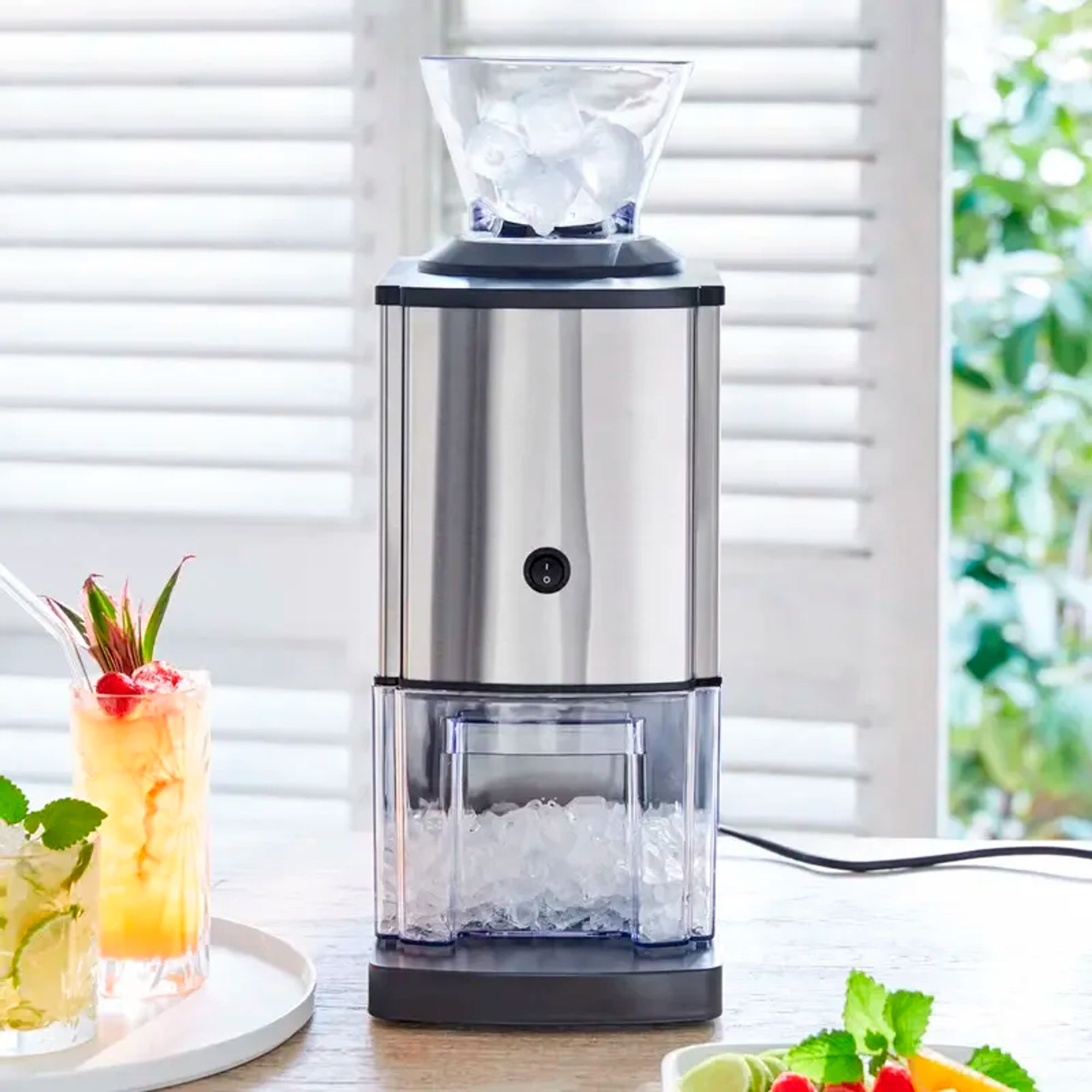 A silver ice maker with ice cubes at the top and bottom.