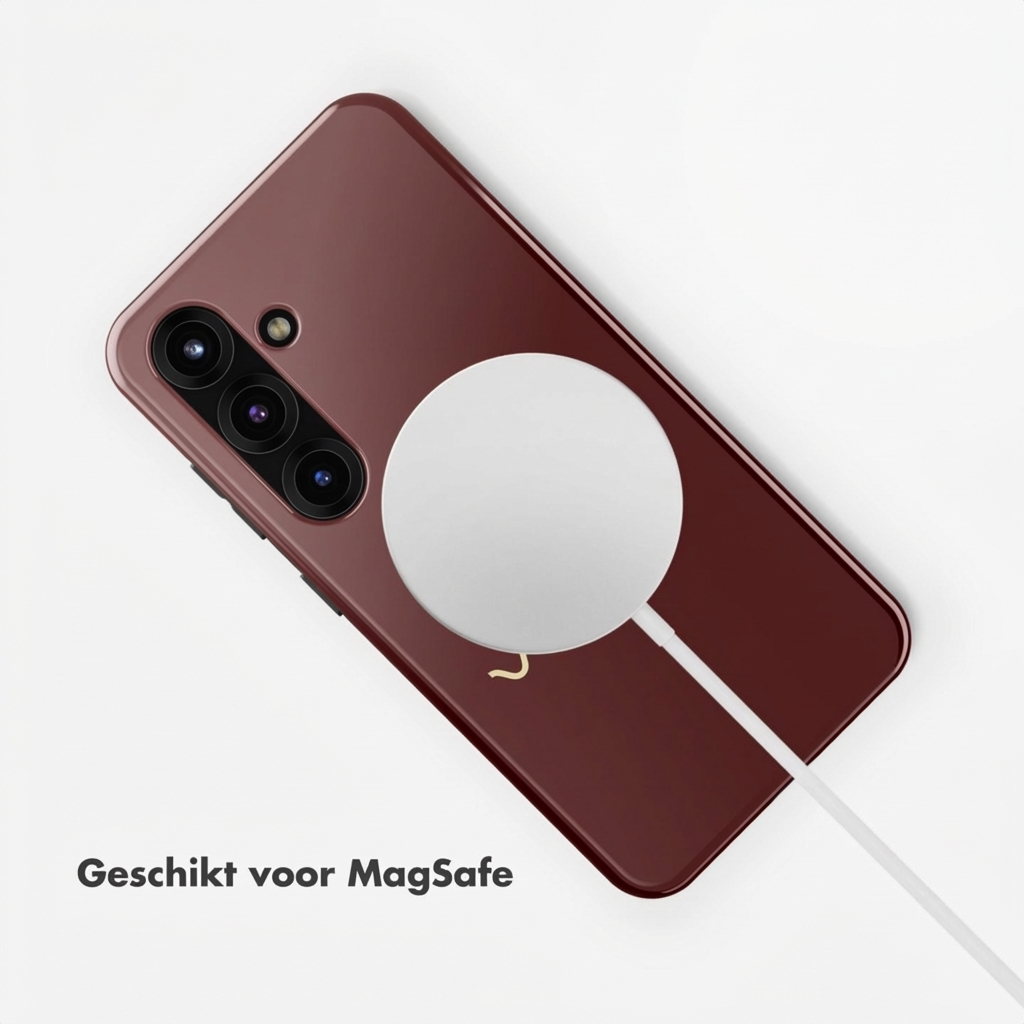 Téléphone rouge foncé avec chargeur MagSafe et câble sur fond blanc.