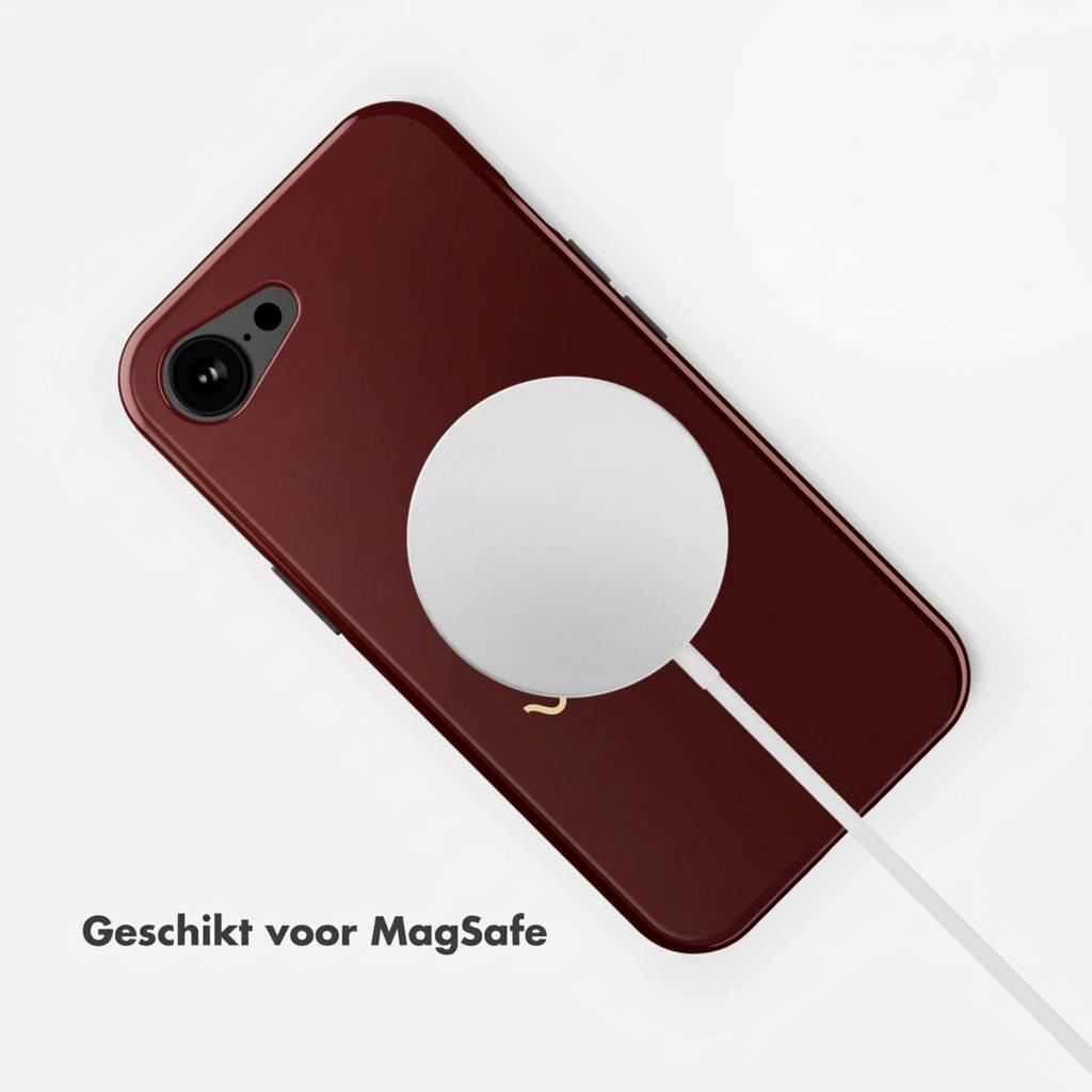 Un iPhone rouge foncé avec chargeur MagSafe et câble sur fond blanc.