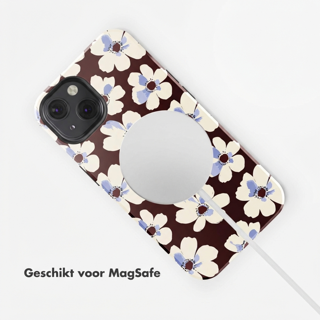 Custodia marrone per telefono con motivo floreale, caricatore MagSafe e cavo bianco.