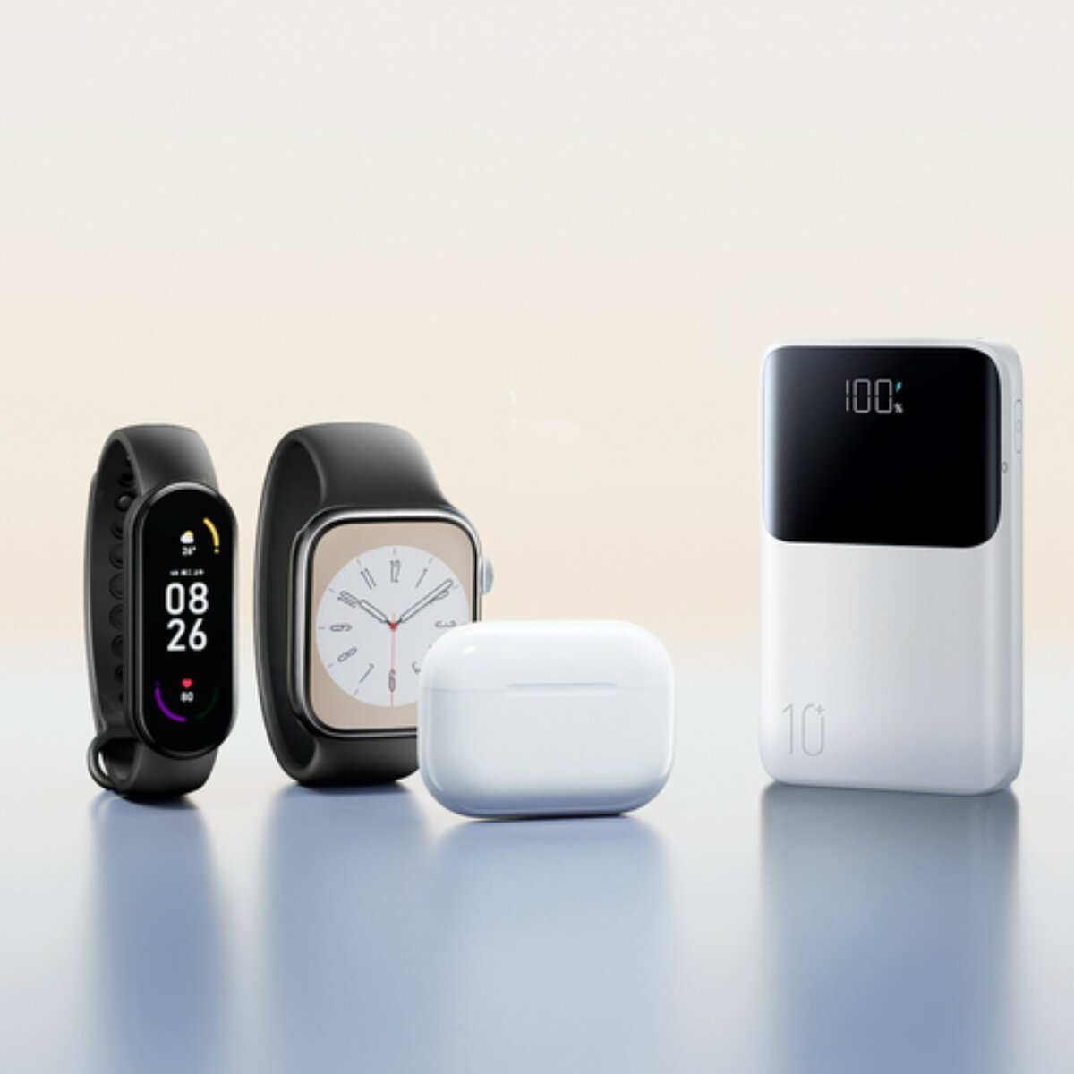 Drei Gadgets: schwarzes Smartband, weiße Kopfhörerbox und weißer Akku.