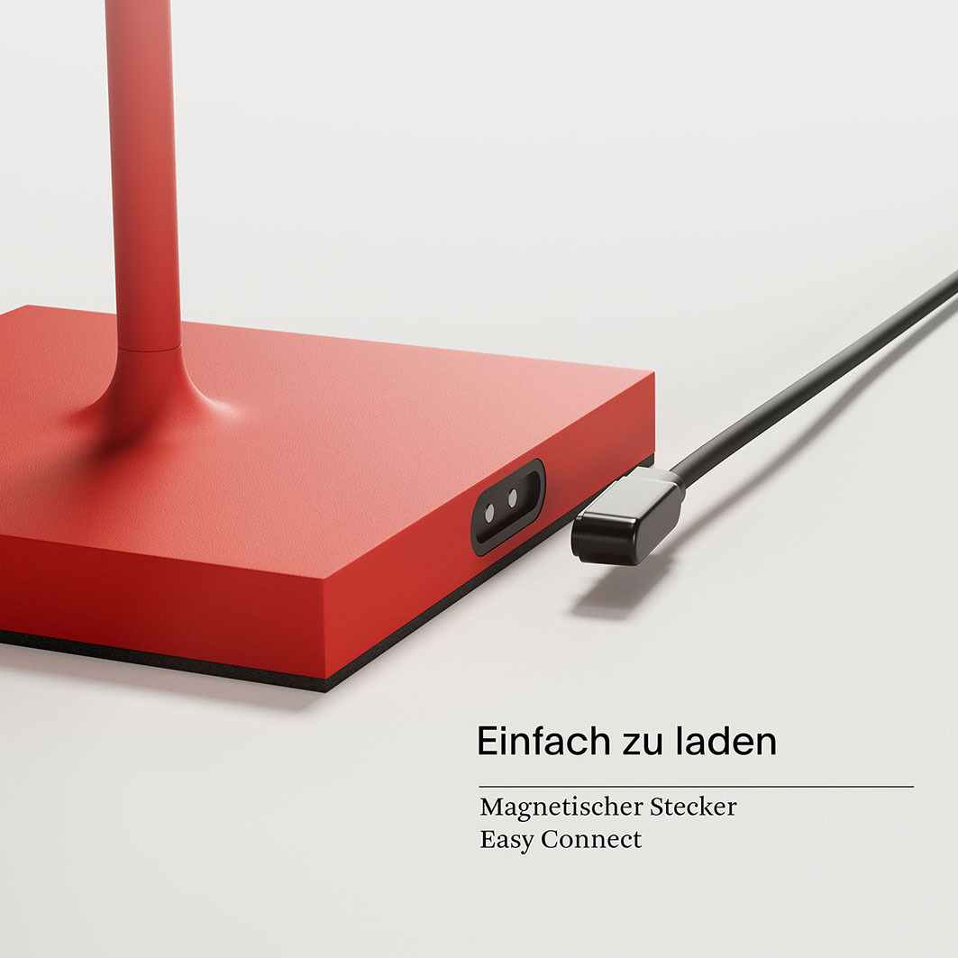 Roter Lampenfuß mit Magnetstecker und schwarzem Kabel. Einfach zu laden.