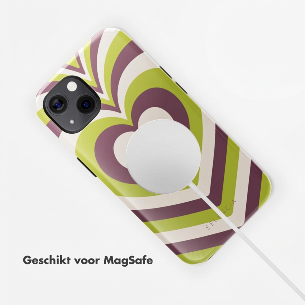 Un téléphone avec un motif de cœurs aux couleurs verte, violette et crème, attaché à un chargeur MagSafe.
