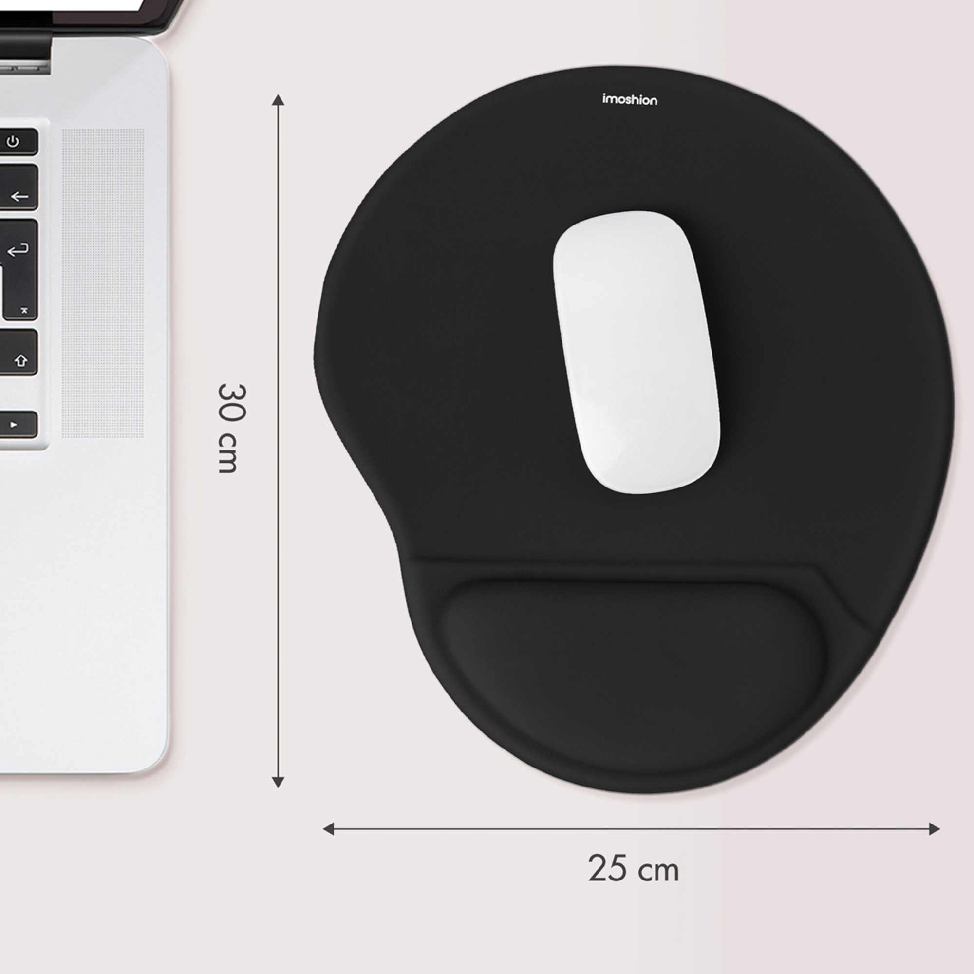 Black mousepad with wrist rest and white mouse next to a laptop.