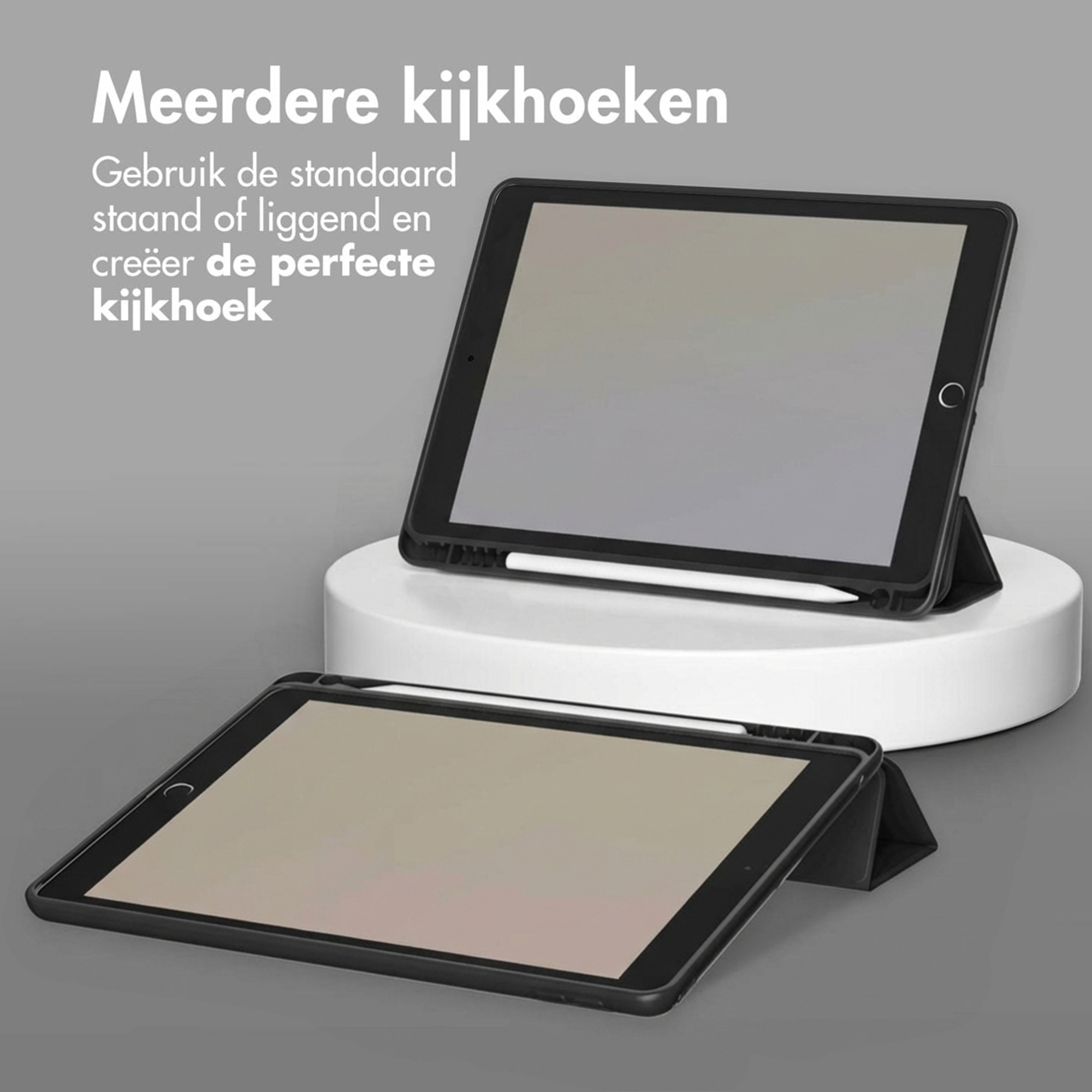 Two black tablets with styluses in stands on a grey background.