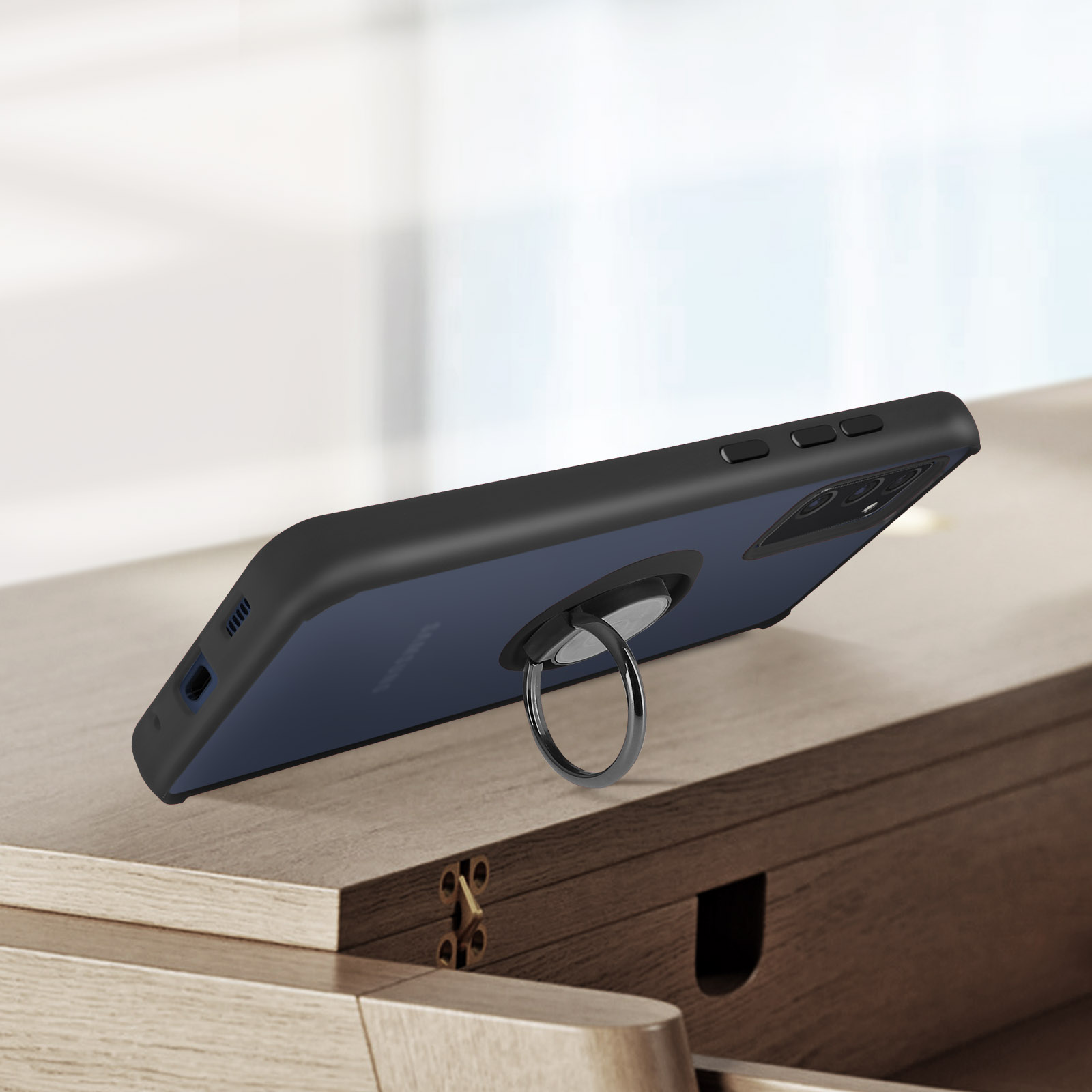 Smartphone met ringhouder op houten tafel.