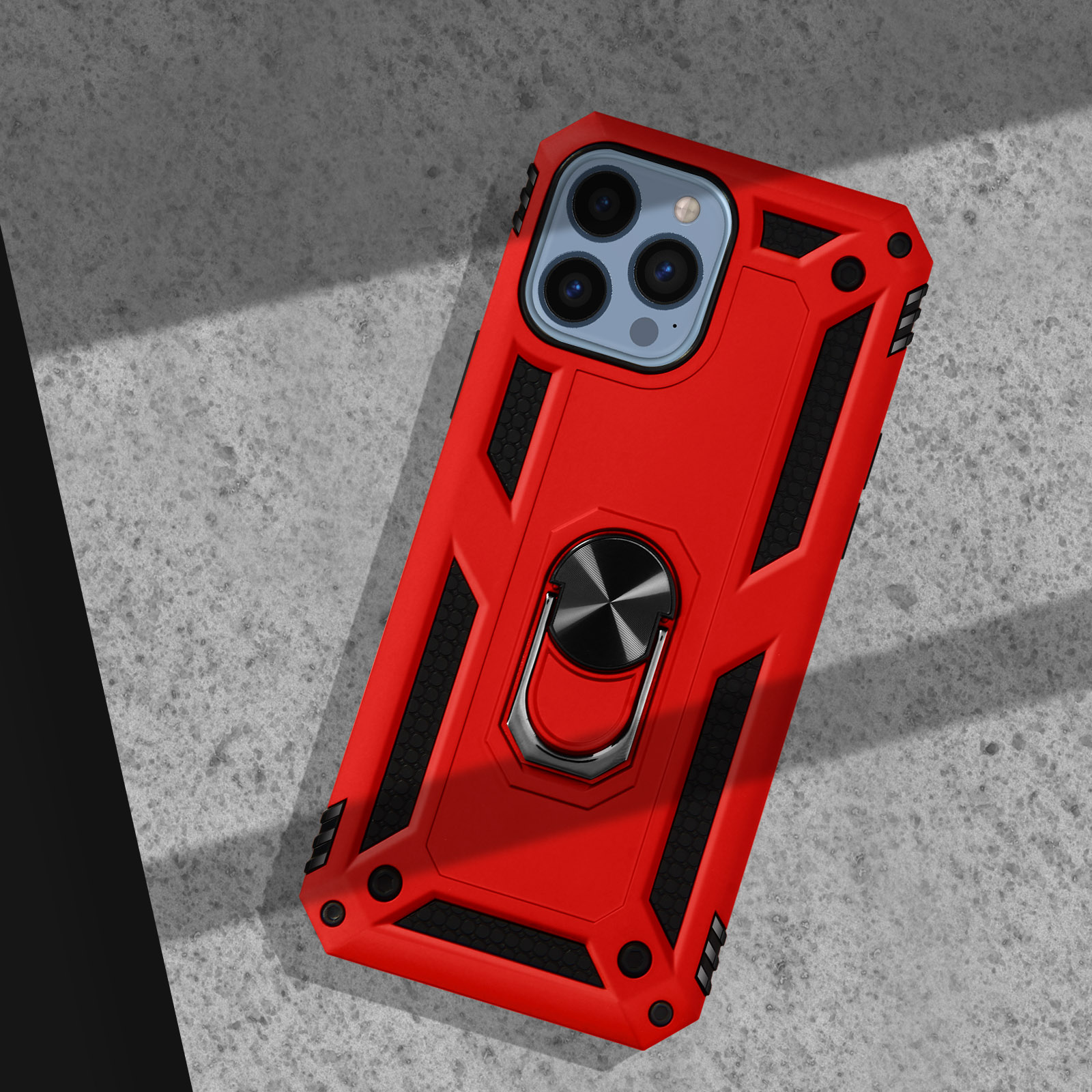 Coque de téléphone rouge avec support anneau sur béton.