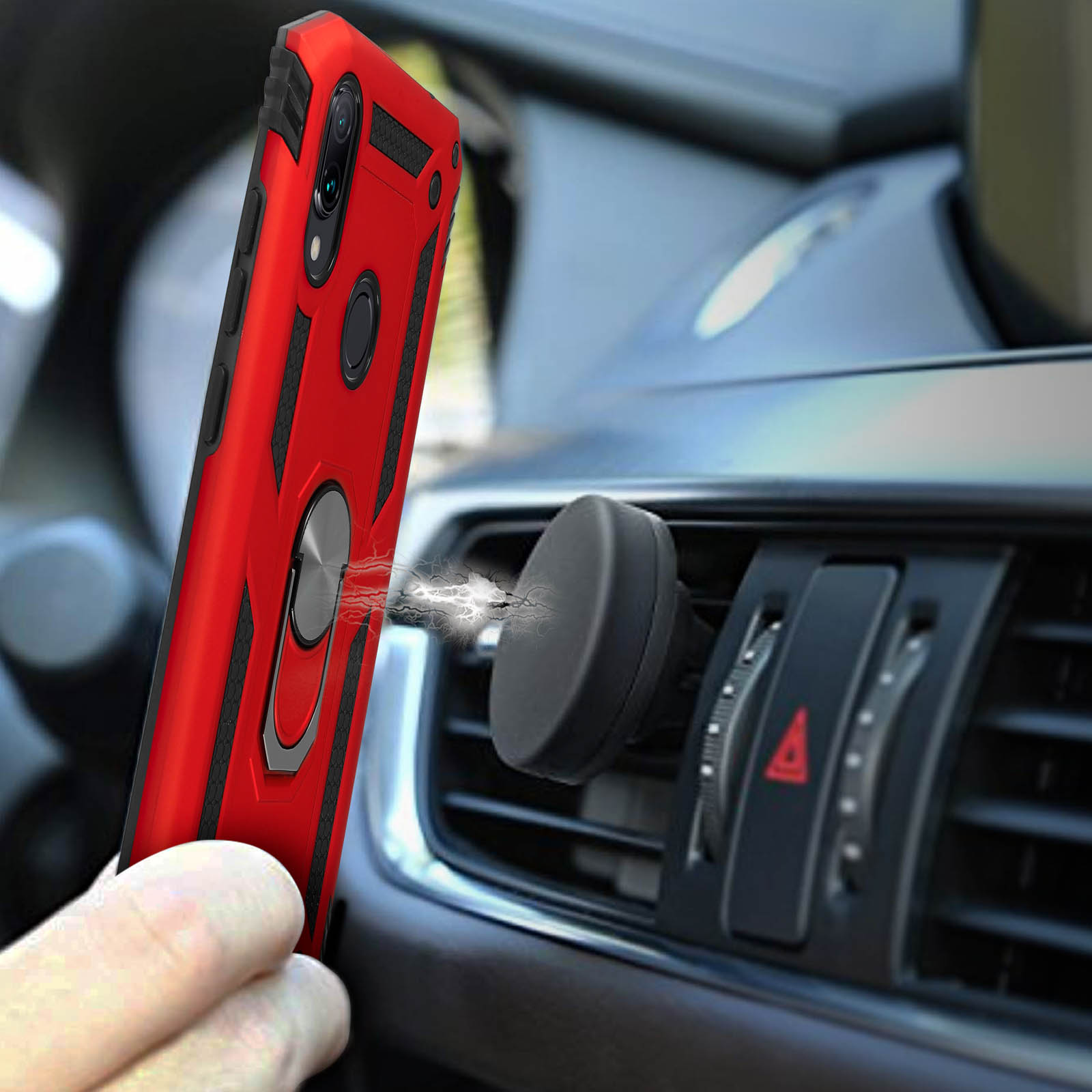 Un téléphone rouge avec un support magnétique sur une grille d'aération de voiture.