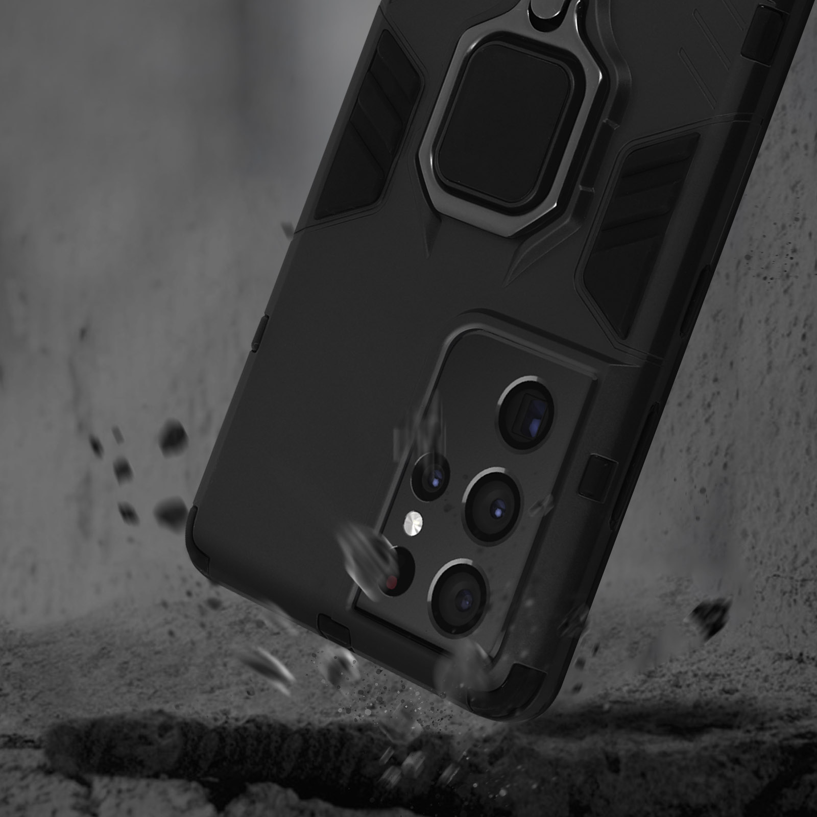 Telefono nero con anello portaoggetti cade sul cemento. Fotocamere visibili.
