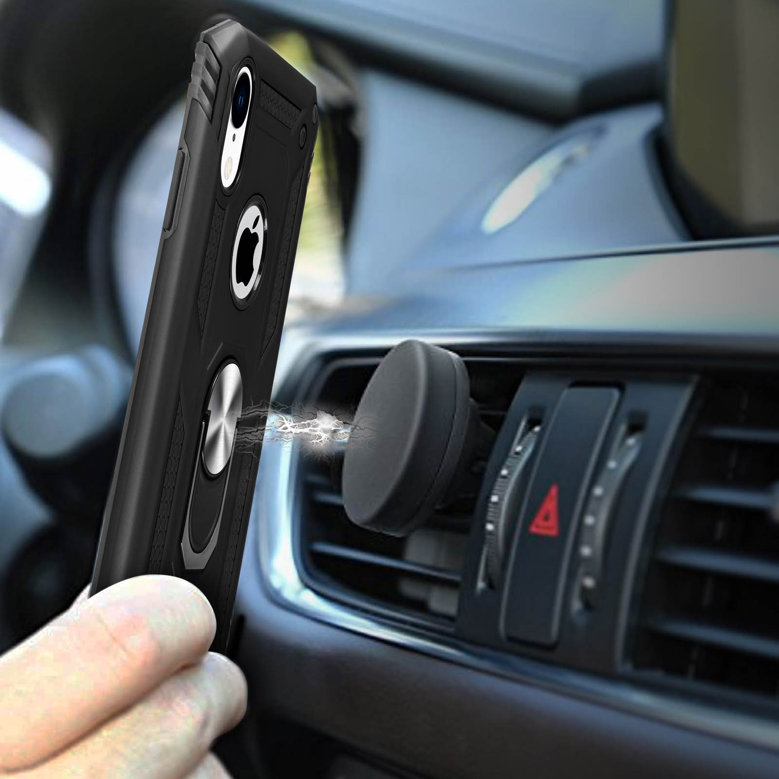 Hand houdt zwarte telefoon met ringhouder bij auto-ventilatie.