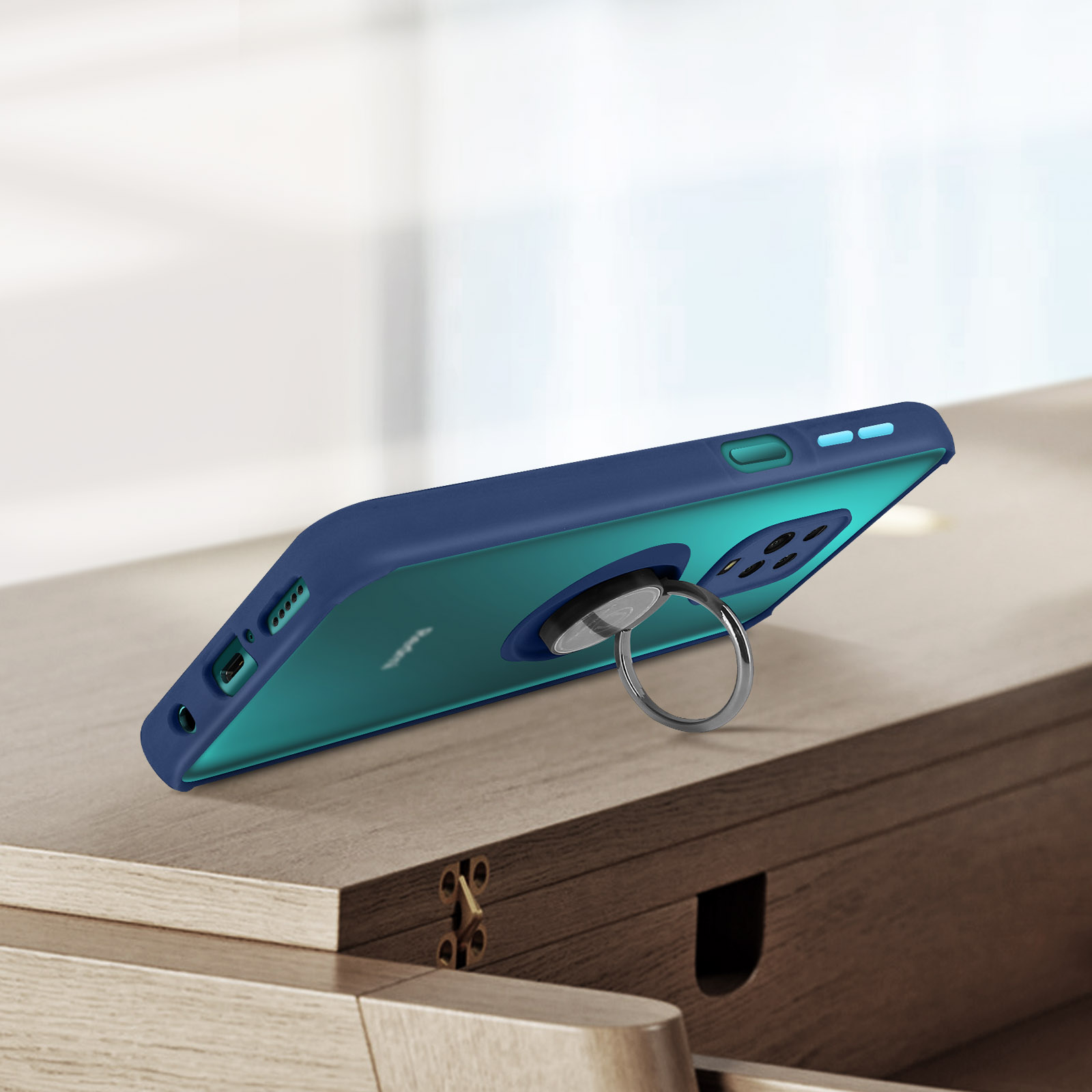 Coque de téléphone bleu foncé avec support anneau sur table