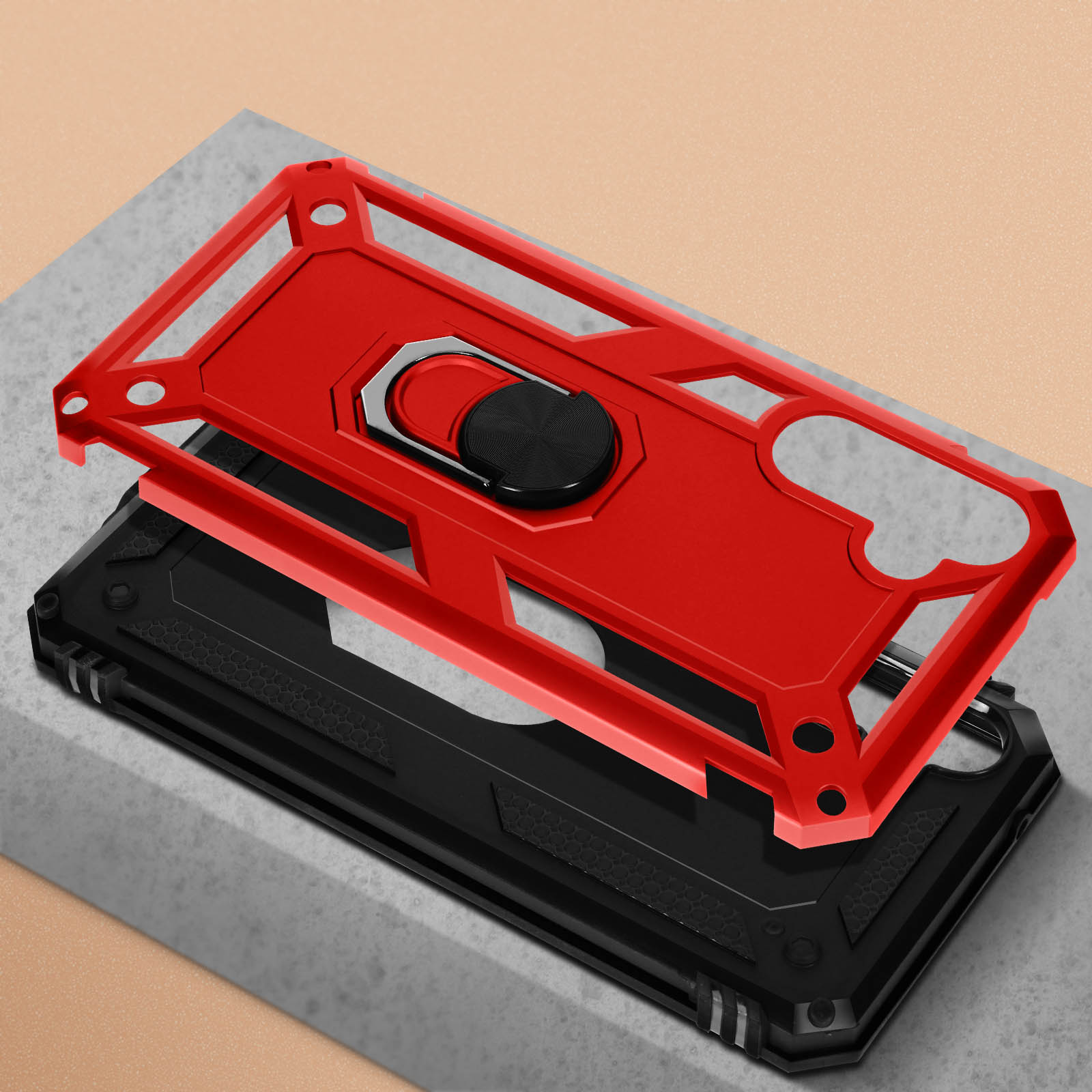 Coque de téléphone rouge et noire avec support bague sur socle en pierre.