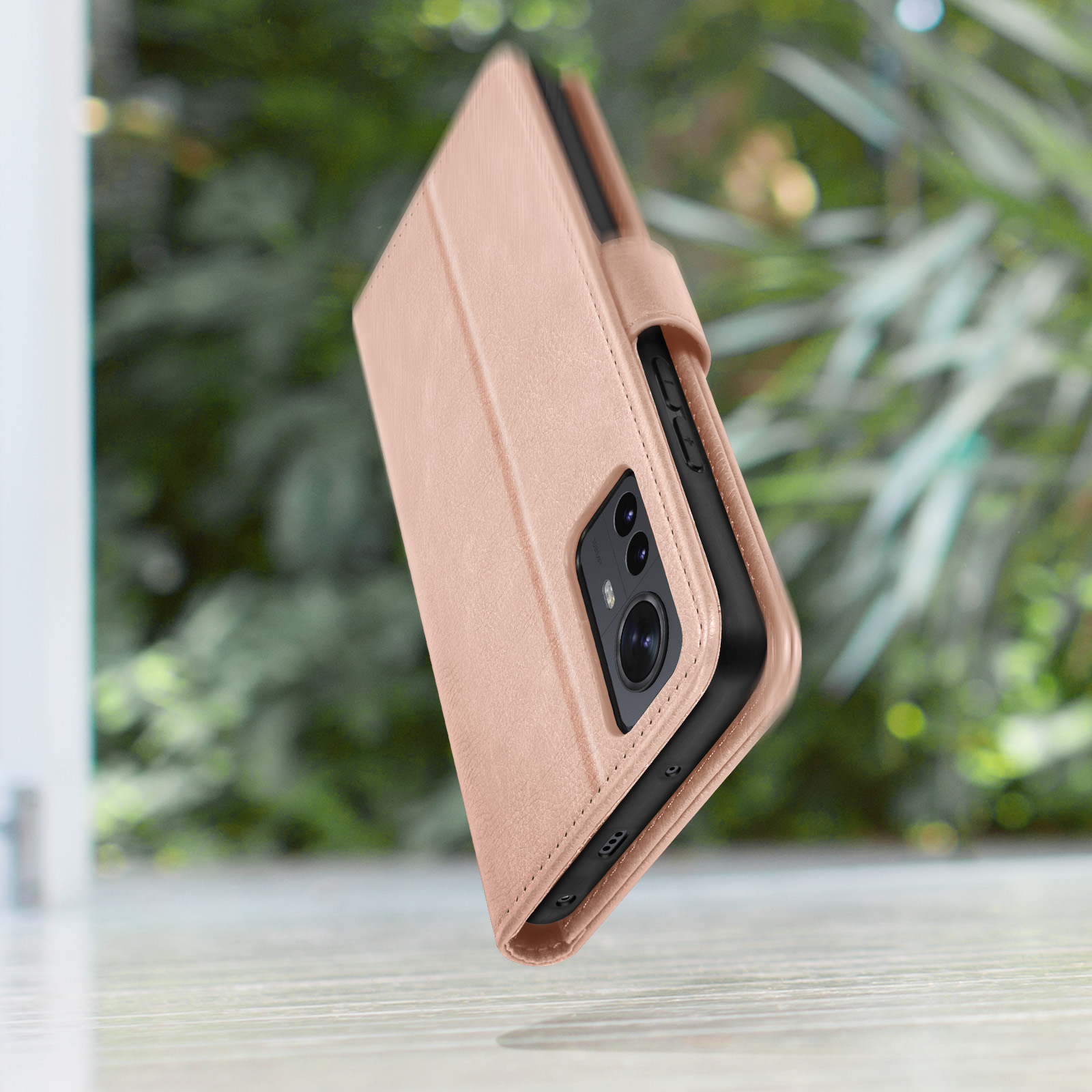 Un étui portefeuille rose doré pour téléphone avec trois caméras.