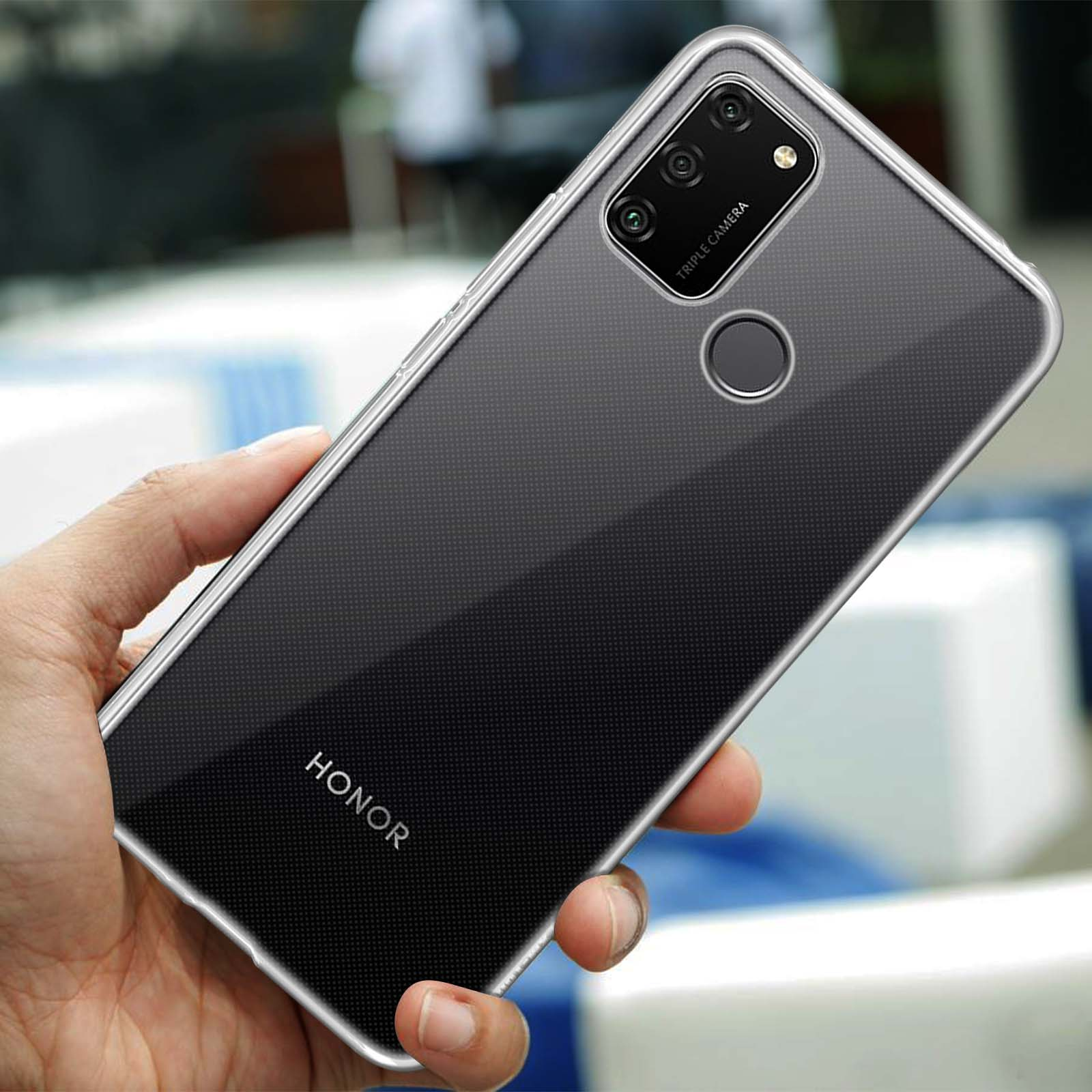 Une main tient un téléphone Honor transparent avec triple appareil photo et capteur.