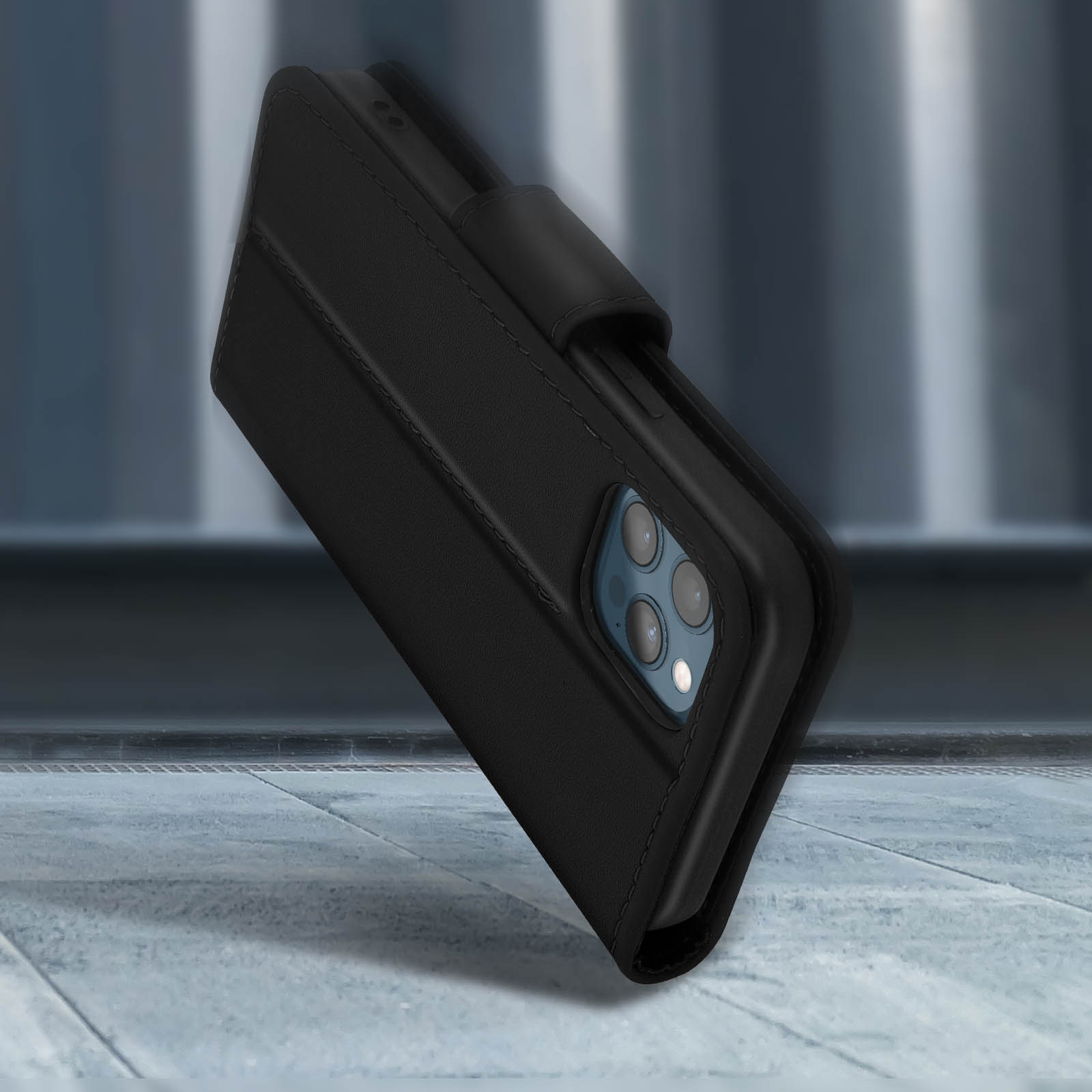 Zwarte lederen telefoonhoes met camera-uitsparingen op stenen ondergrond.